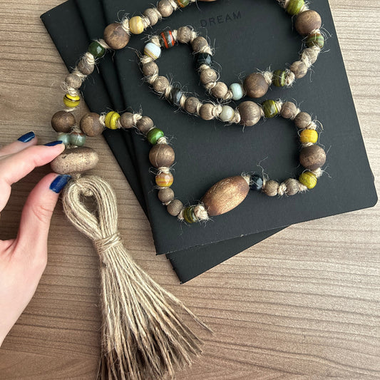 Natural wooden and glass beads styled in a modern boho interior