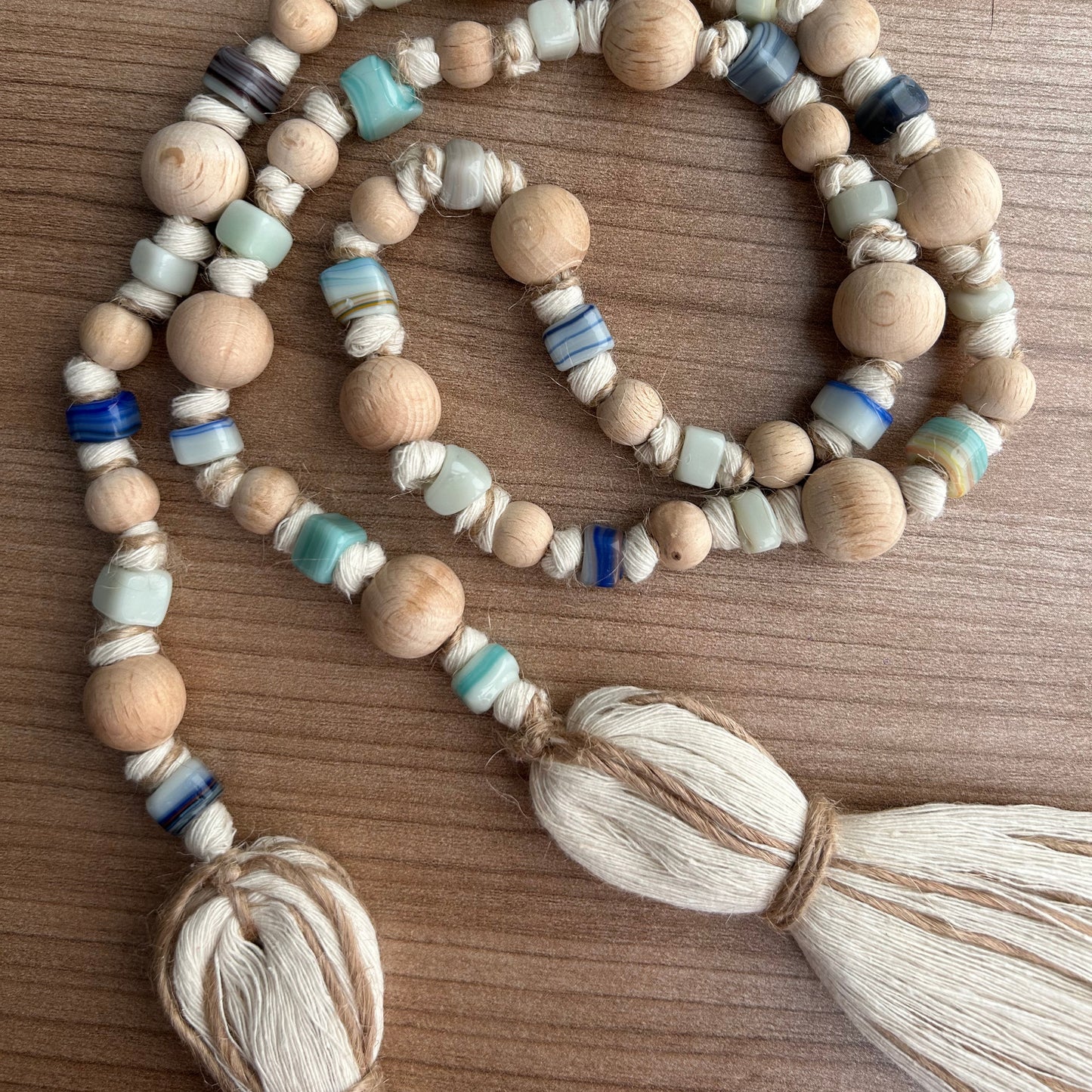 Handmade boho garland showcasing soft beige, brown, and blue glass bead color palette.