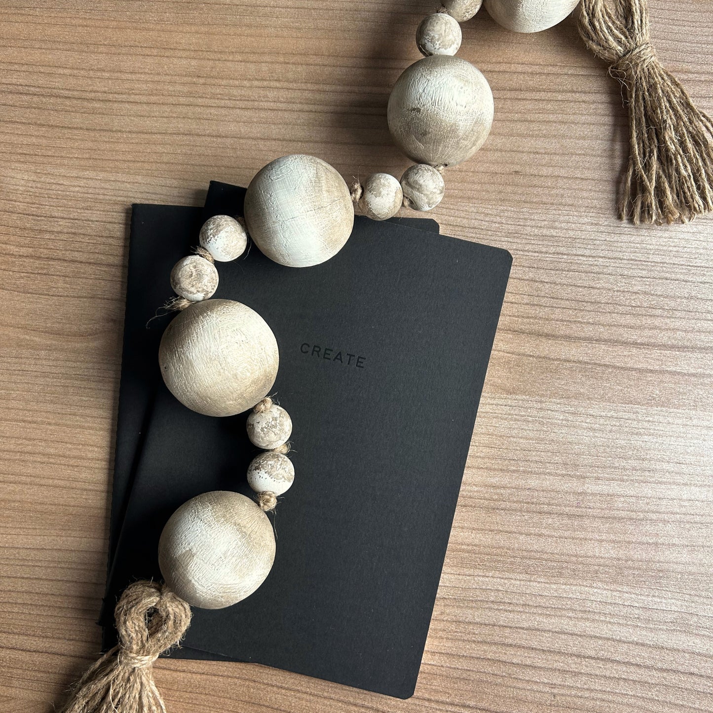 Boho style wood bead garland on tabletop