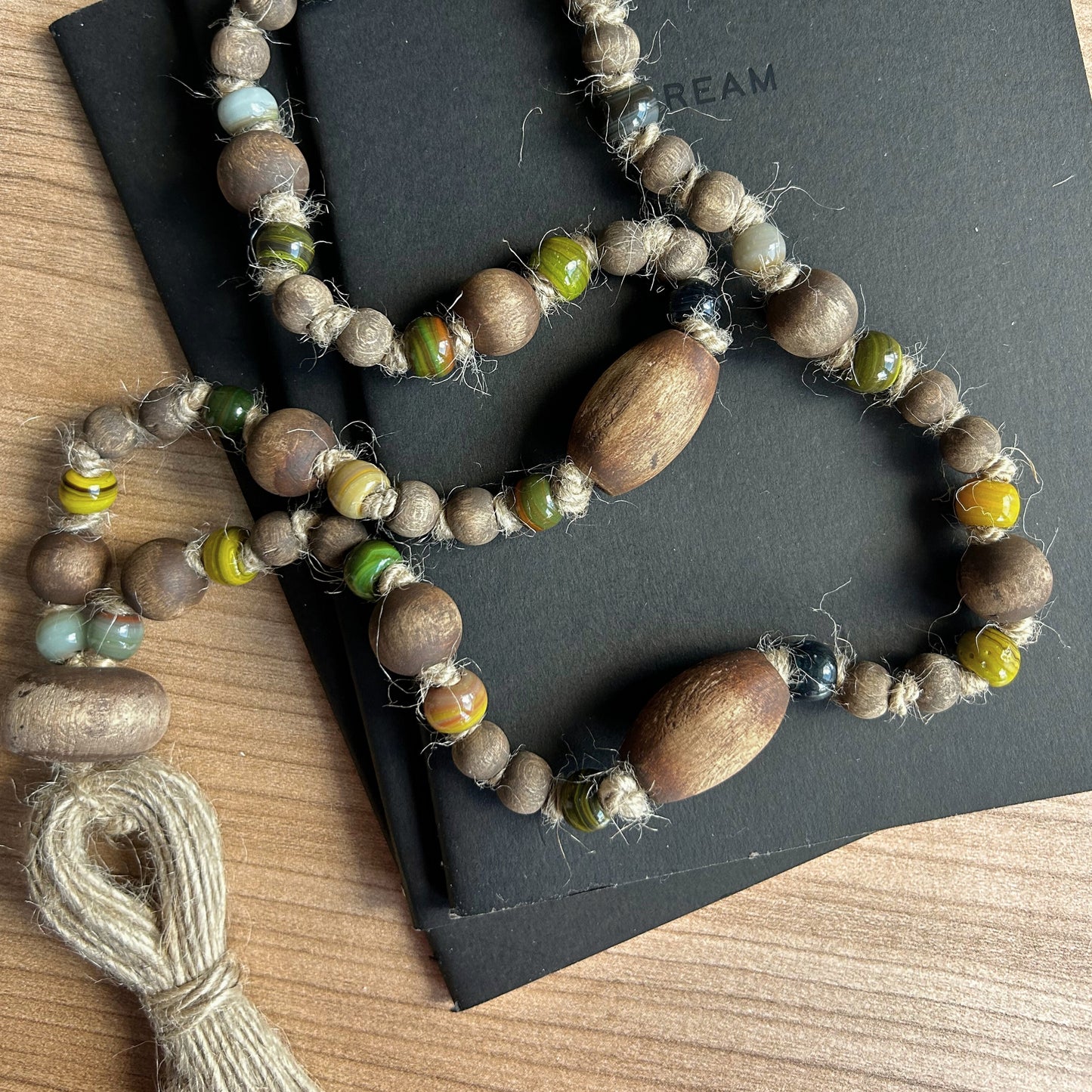 Close-up of handcrafted wooden and glass beads in earthy tones