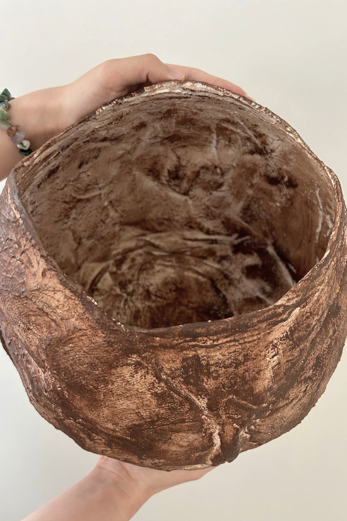 Underside view of the handcrafted vase, showing the form and artisan finish of the base.