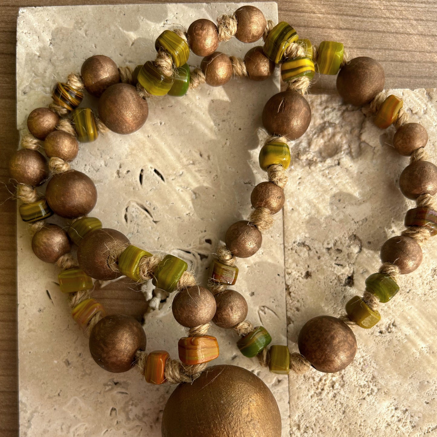 Fall-inspired bead garland centerpiece in earthy green and amber tones.