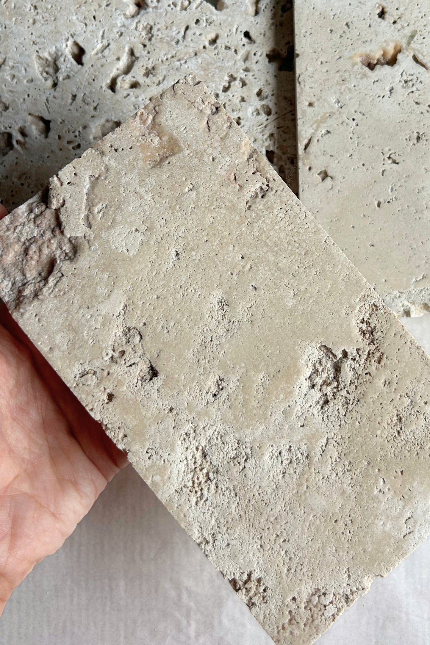 Close-up view of porous texture on raw travertine photo styling prop