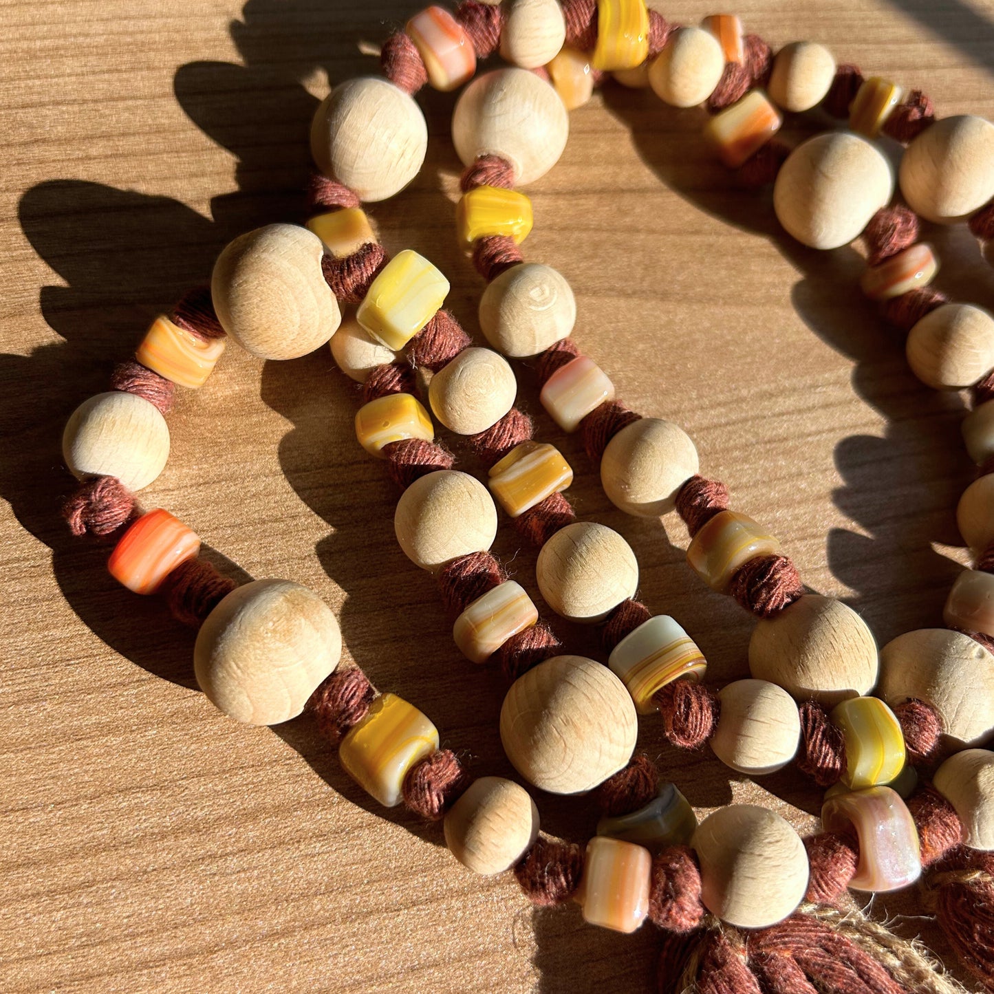 Close-up of wooden and glass beads reflecting light, boho home decor