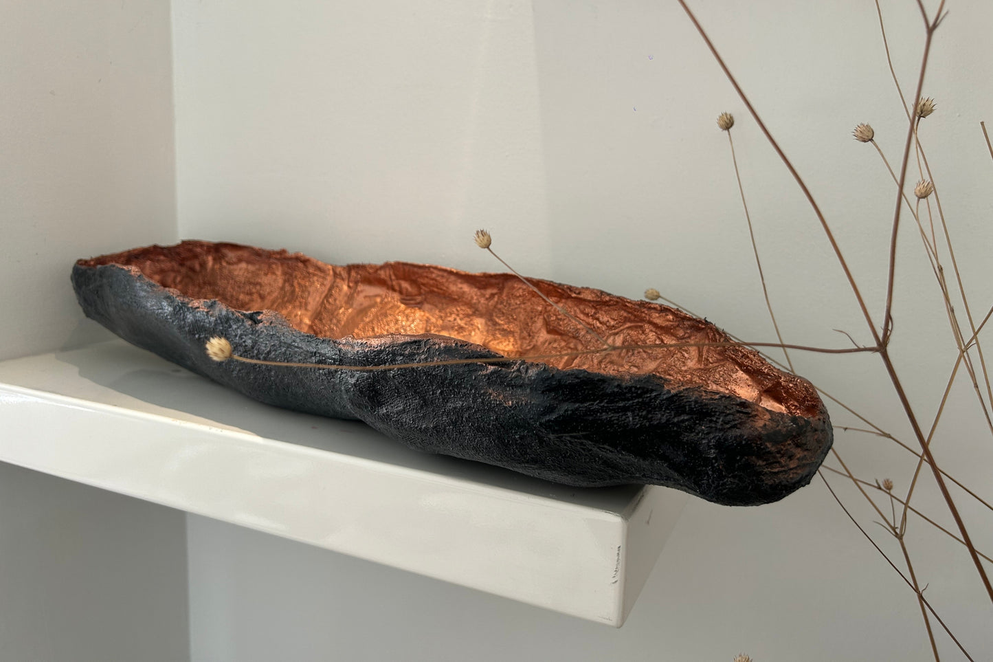 Handmade copper wabi sabi bowl styled on a modern white table with natural light.