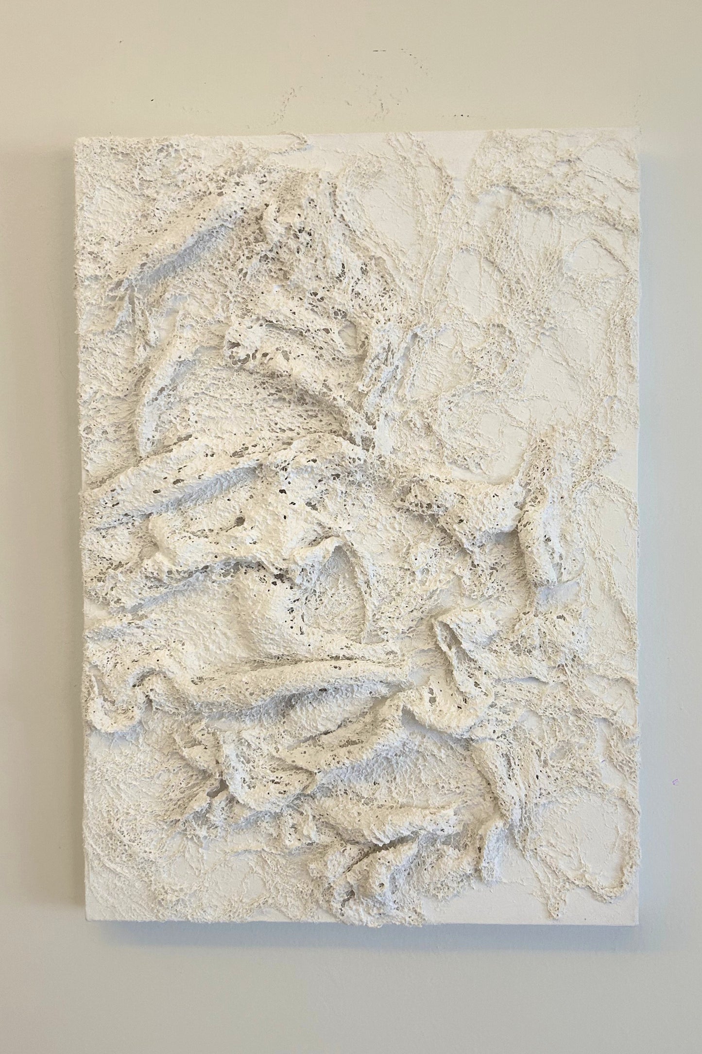 Elegant vertical 3D plaster wall art in neutral tones, inspired by coral reefs and marine textures.