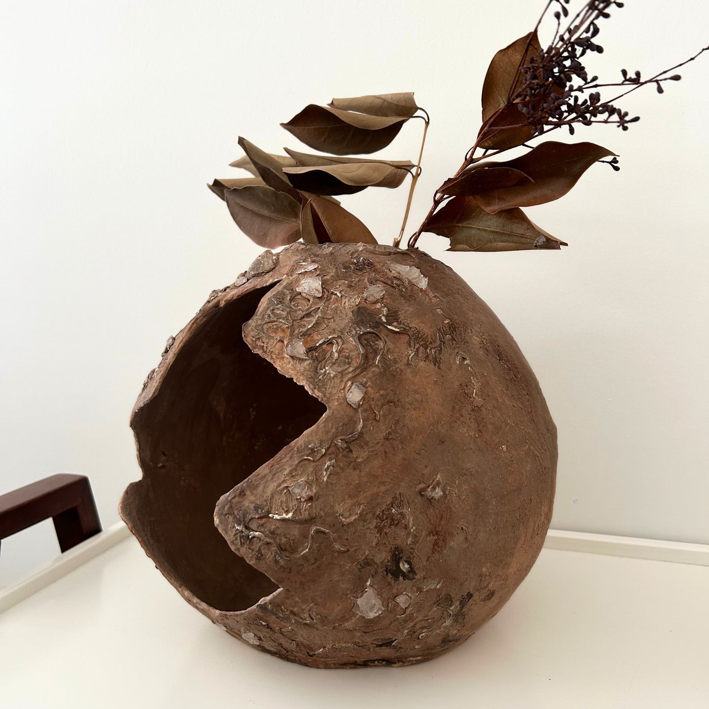 Wabi sabi decorative bowl styled with dried botanical leaves – rustic boho tabletop styling
