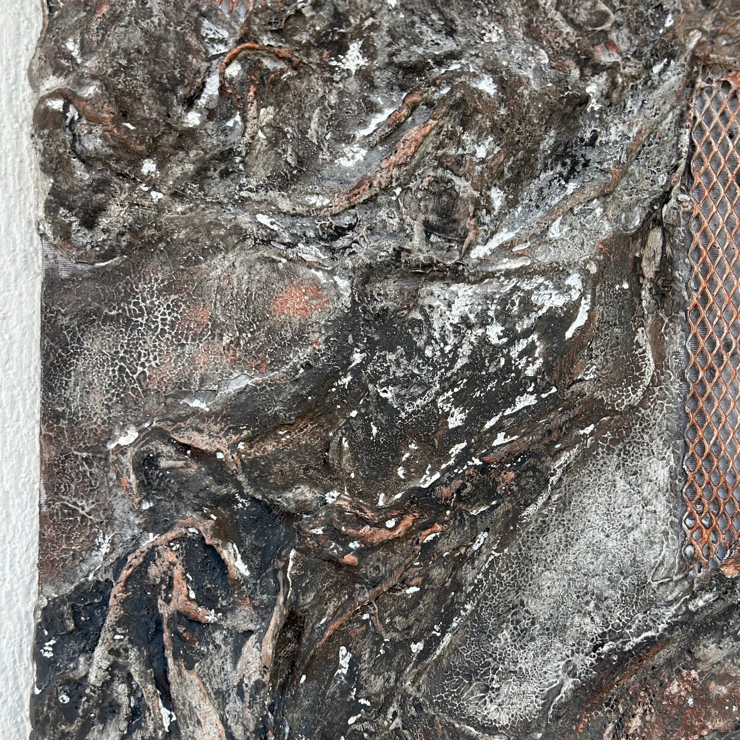 Close-up of the left upper texture showing organic relief and copper grid details.