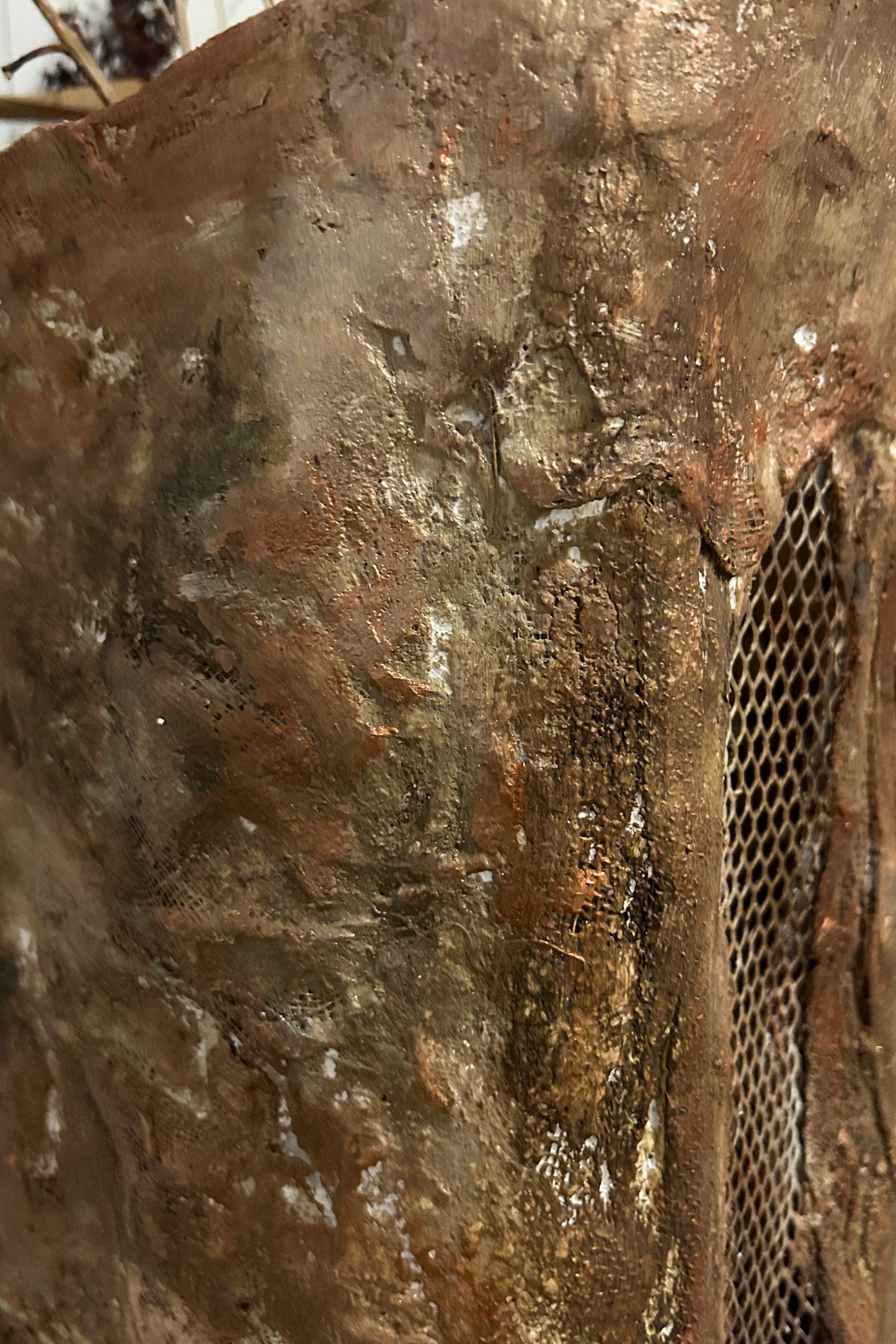 Vertical detail of sculptural surface texture on handmade tall floor vase