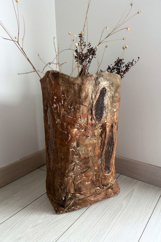 Minimalist room corner with earthy tall floor vase filled with botanicals