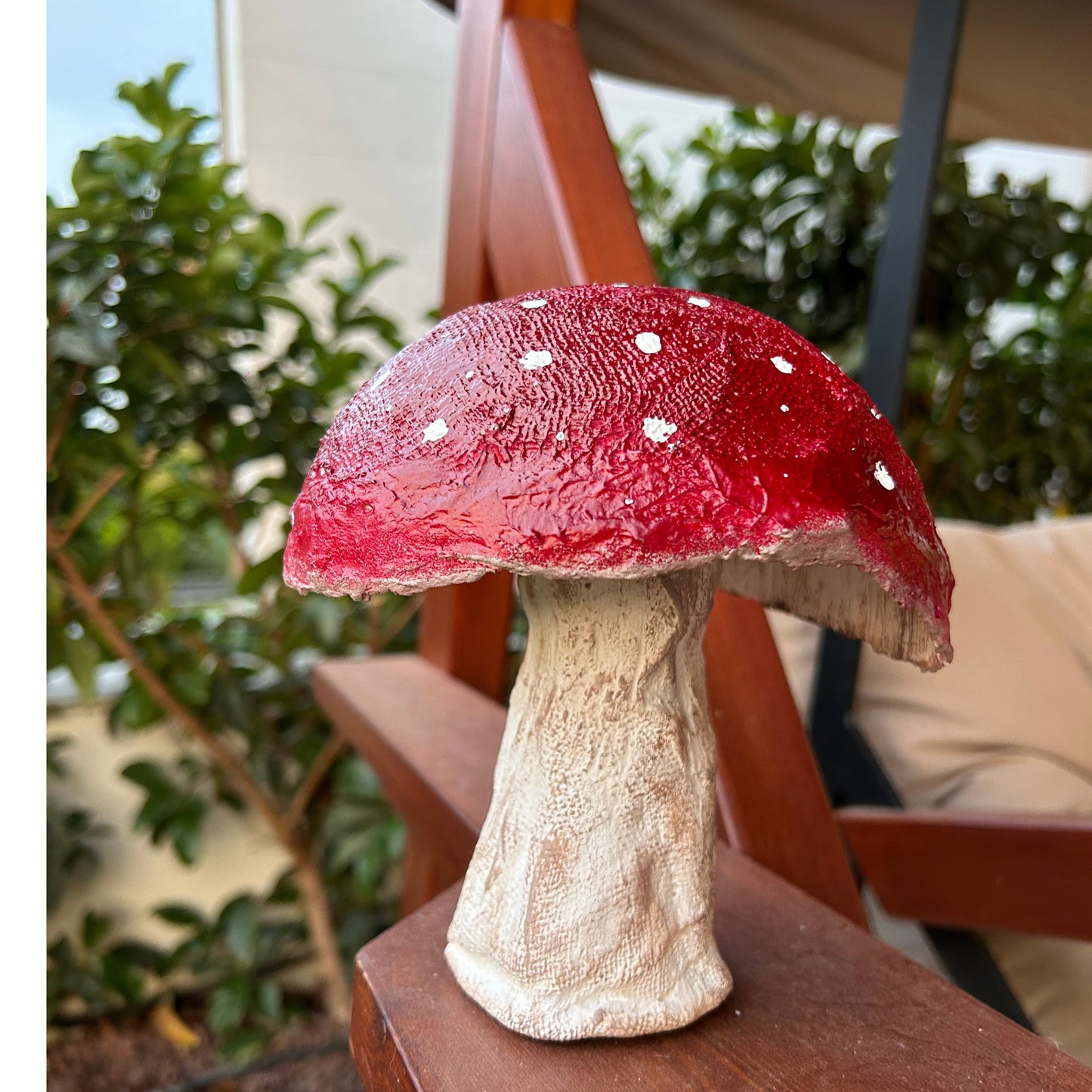 Full front view of handmade red mushroom decor on wooden surface