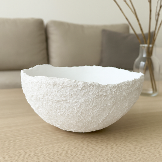 Minimalist handmade wabi sabi bowl sitting near dried florals on an oak console table