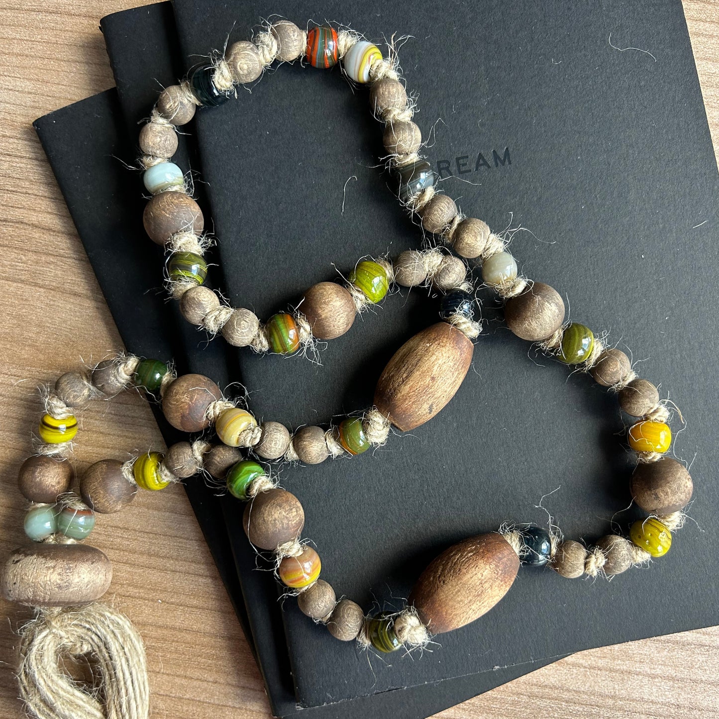 Farmhouse-style garland with glass beads styled on a wooden table