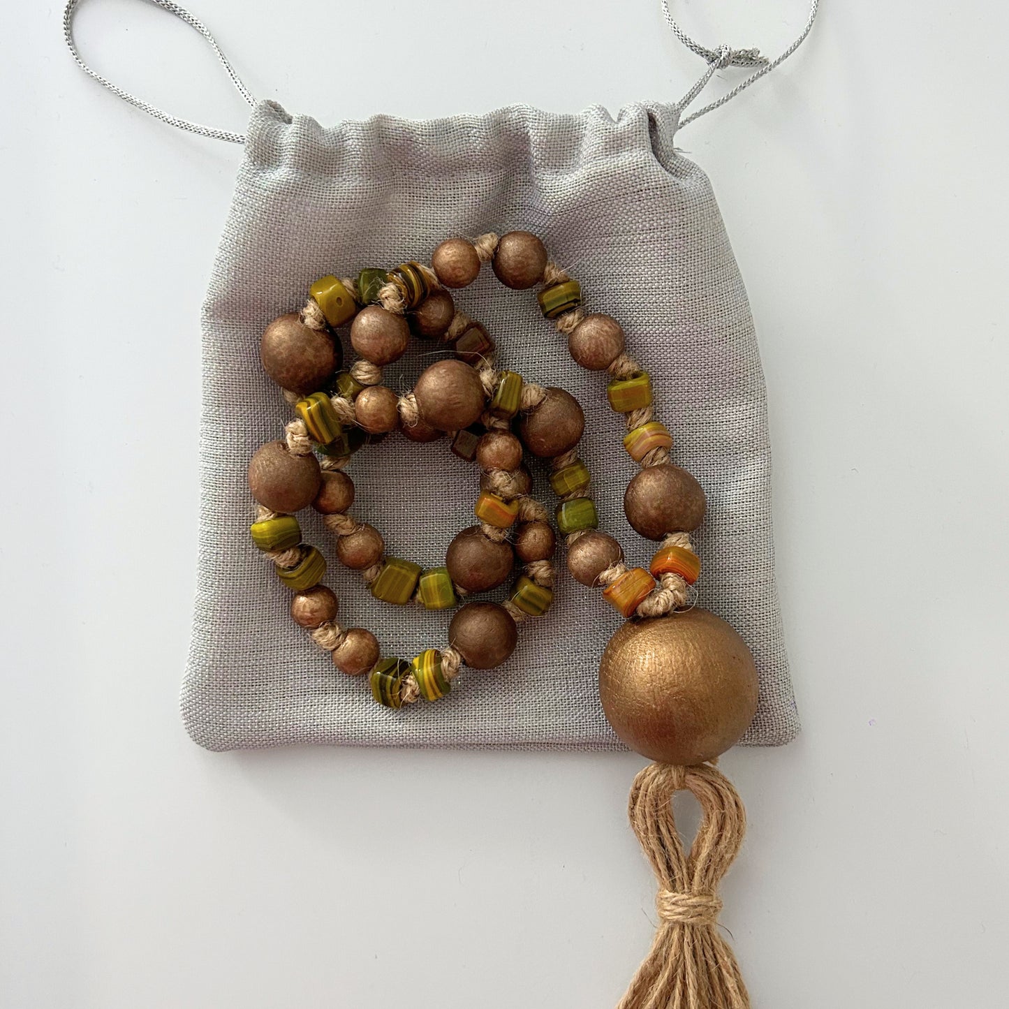 Rustic handmade garland packaged in a soft fabric pouch, ready for gifting