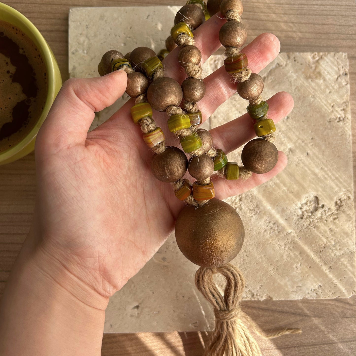 Detailed texture of fall-inspired glass beads styled with jute and wood.