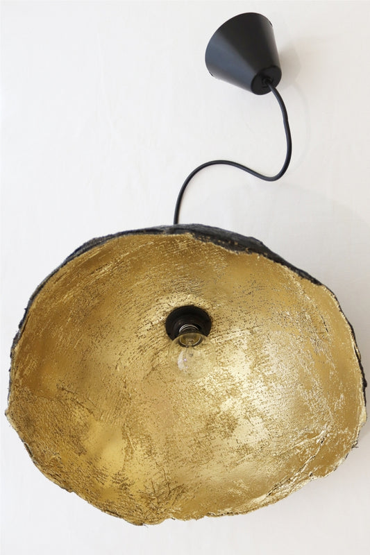 Top view of handmade gold paper mache pendant lamp with visible black cable