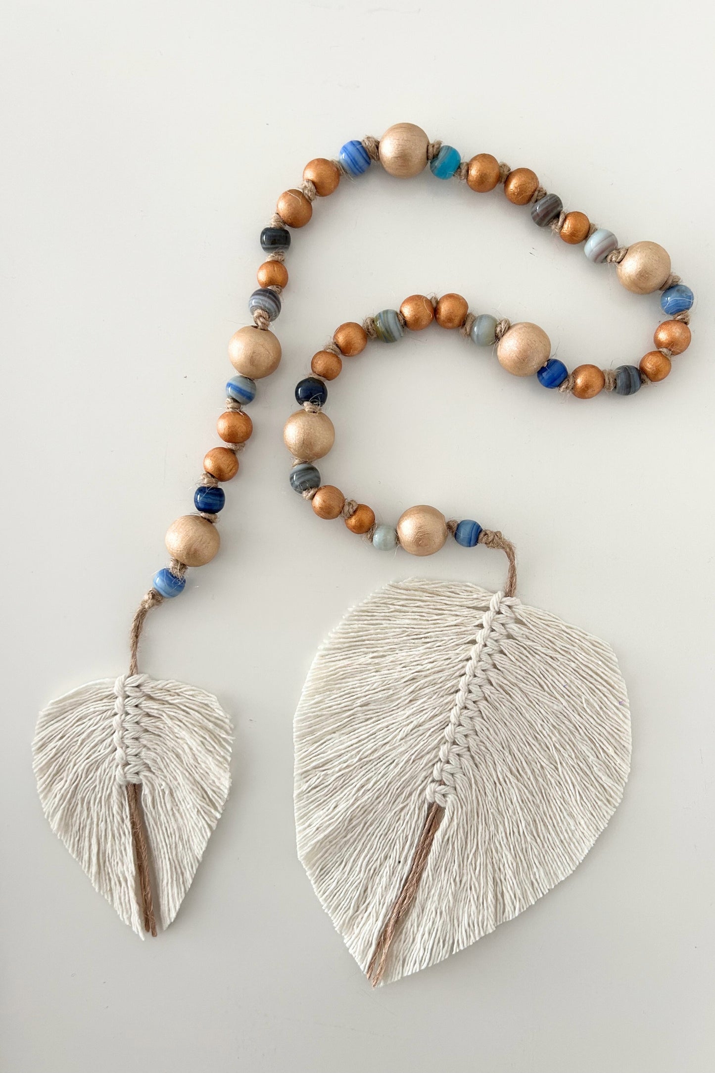 Stylish boho garland with natural textures and artisan details, laid out flat