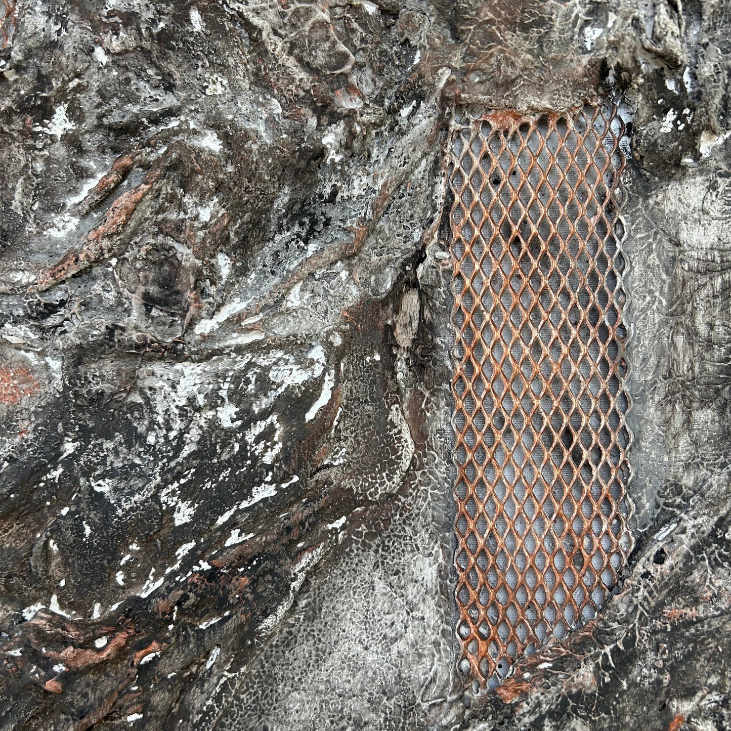 Detailed view of copper mesh embedded in sculptural surface with layered textures.