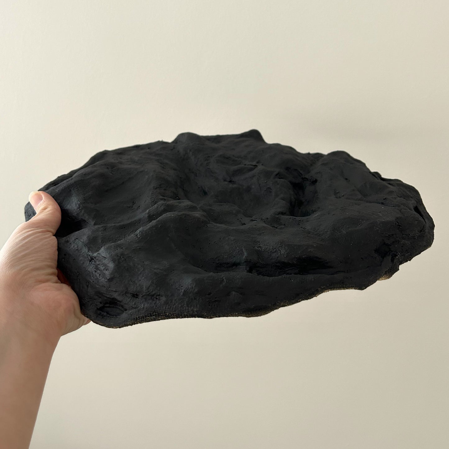 Bottom view of the tray showing its matte black textured base