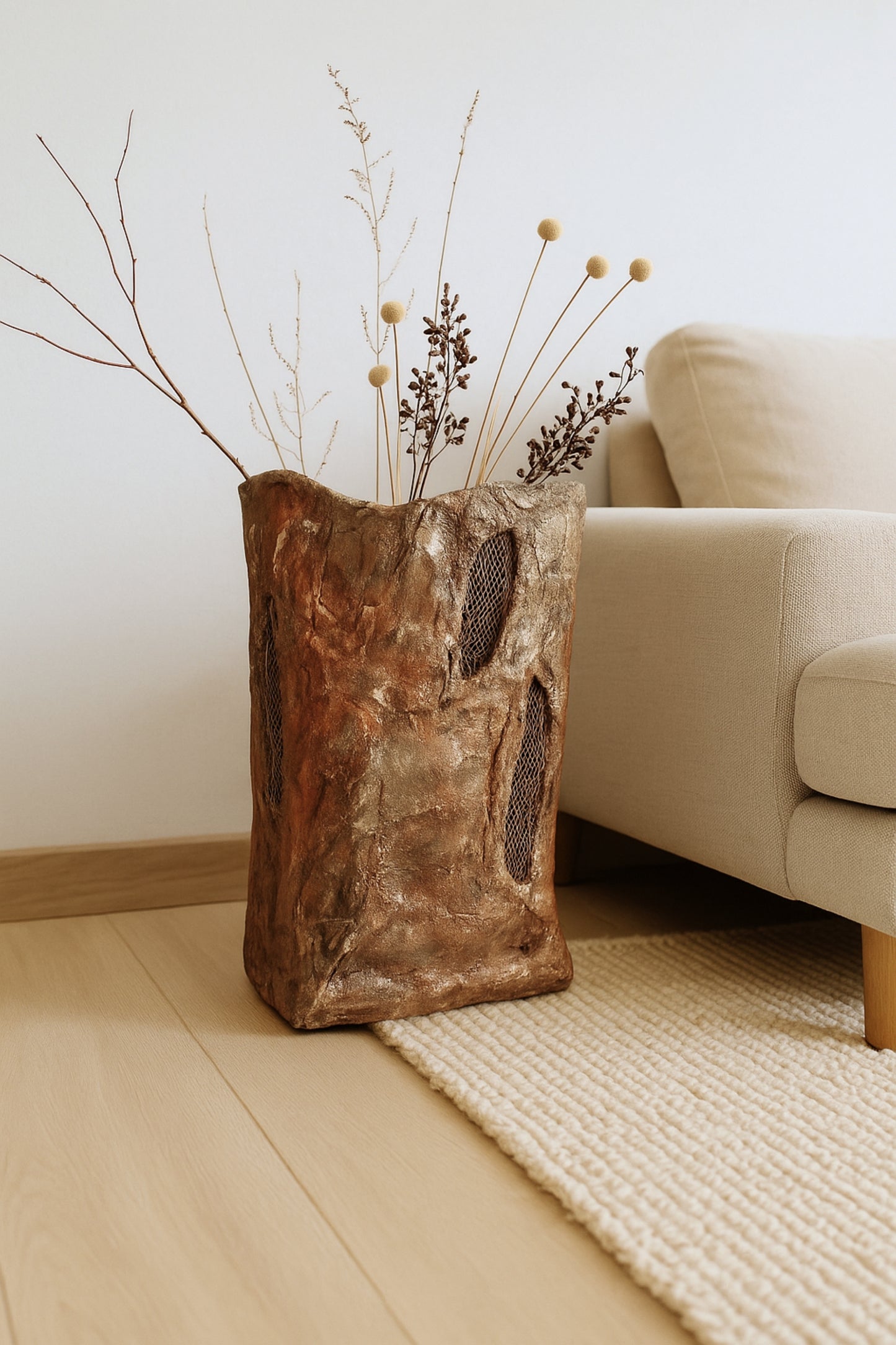 Textured artisan floor vase styled in warm neutral home setting