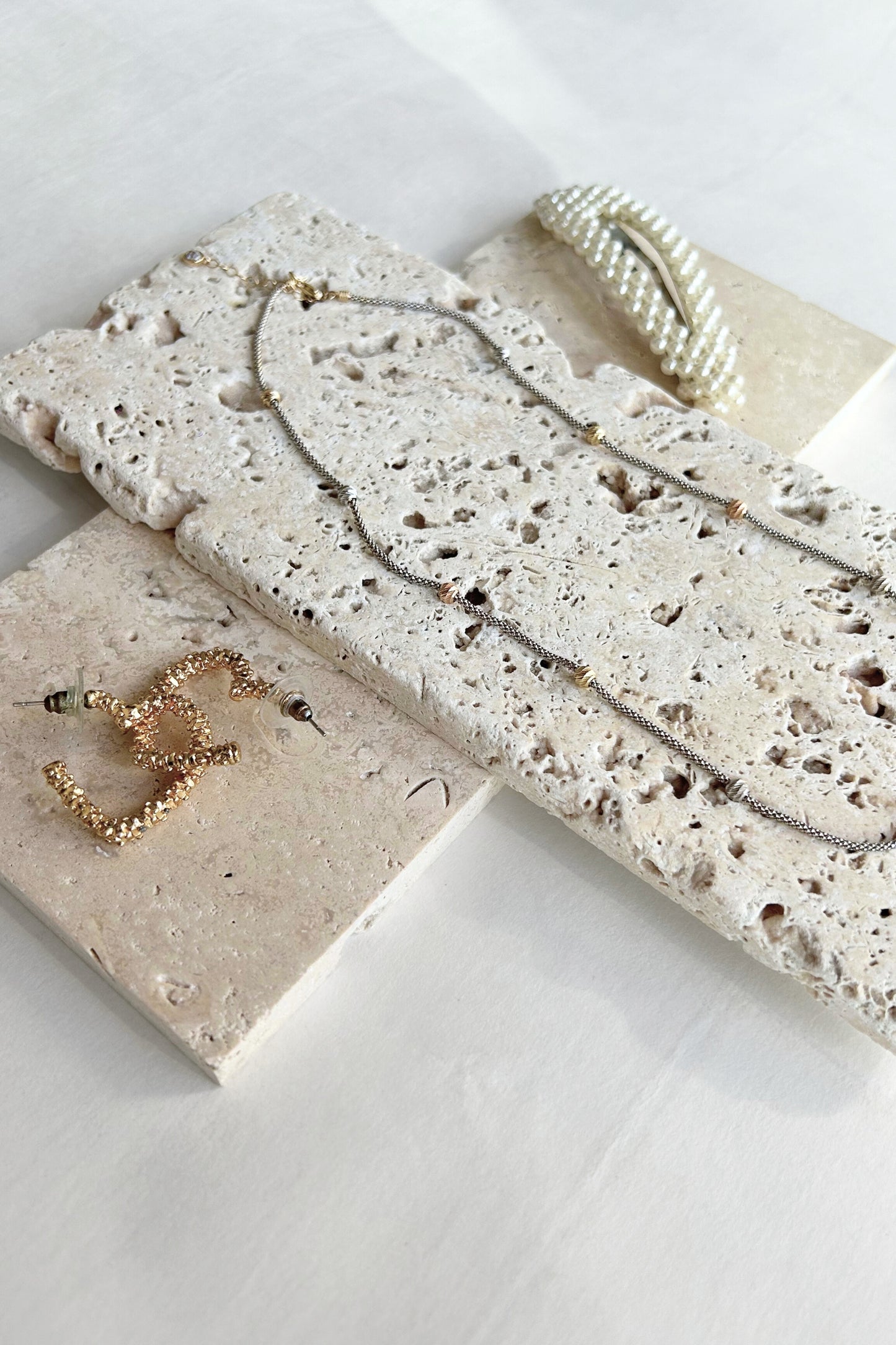 Multiple travertine slabs layered for product photography and minimal styling