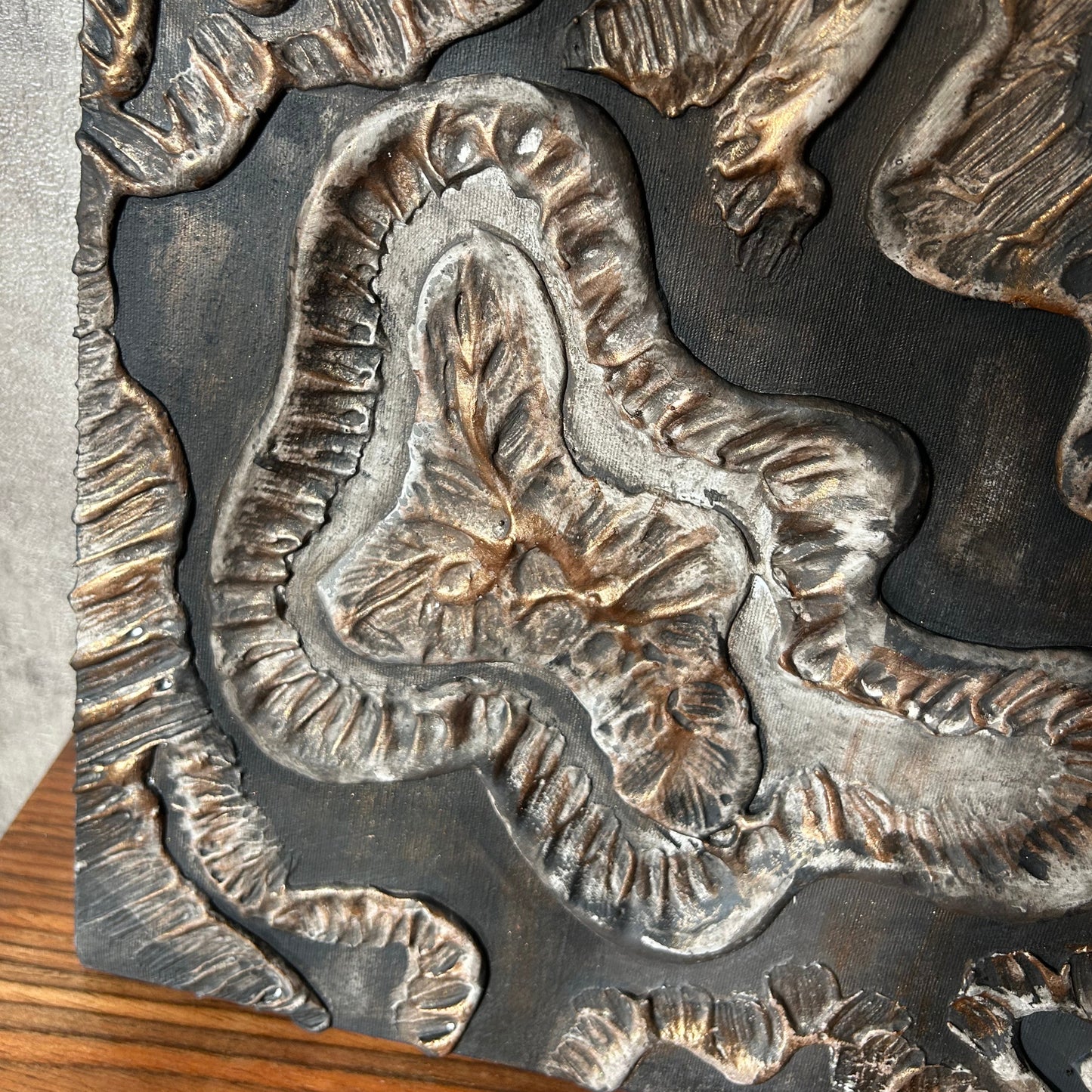 Handcrafted clay and plaster canvas featuring flowing sculptural texture