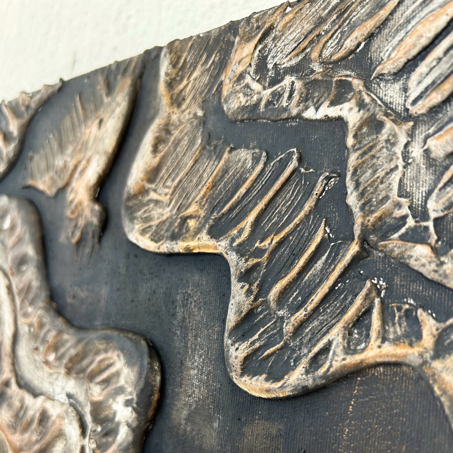 Macro close-up of earthy textured surface with metallic bronze finish