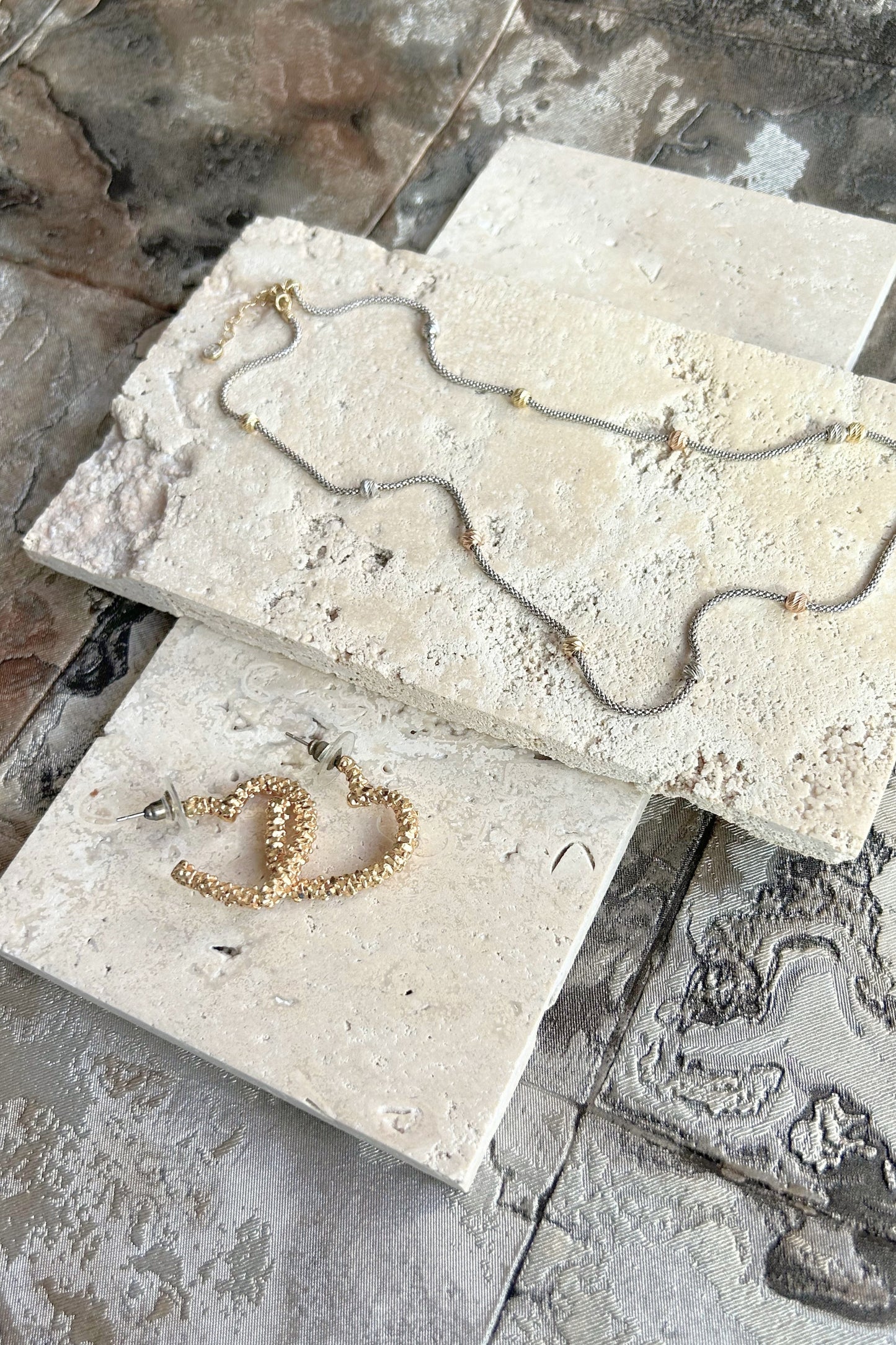 Organic travertine slabs stacked at angle for natural light photography styling