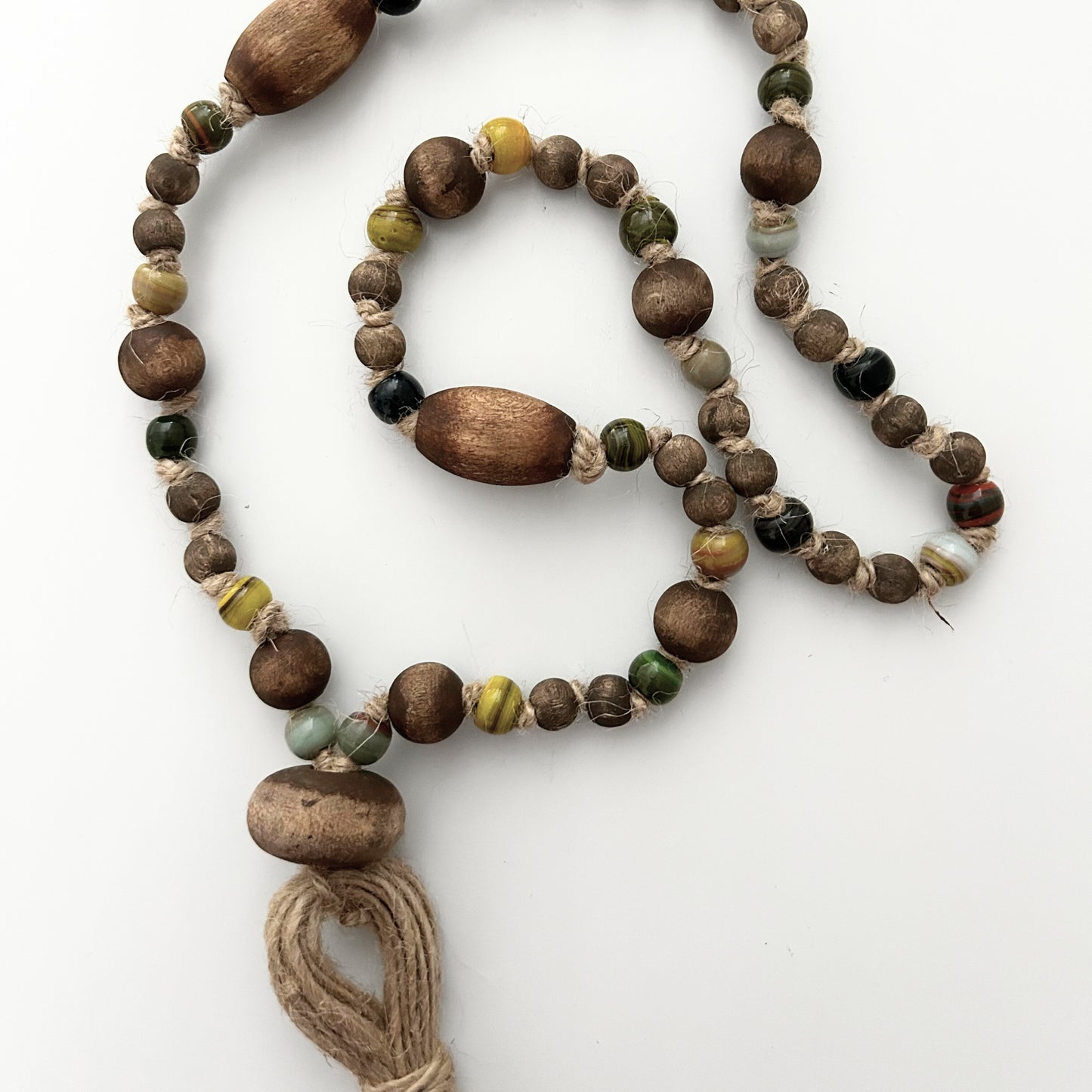Two-strand handcrafted garland with earthy beads and natural fiber tassel