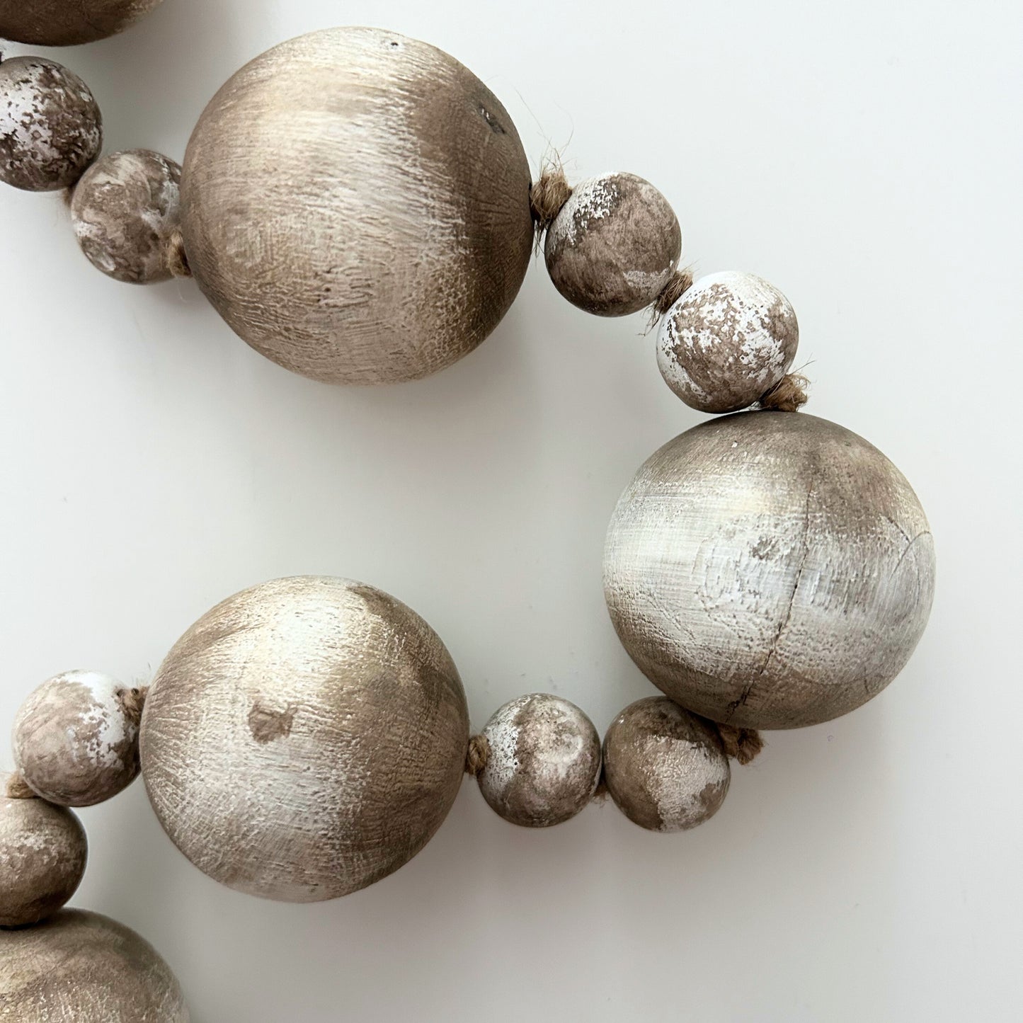 Rustic wooden bead garland highlighting hand-painted texture