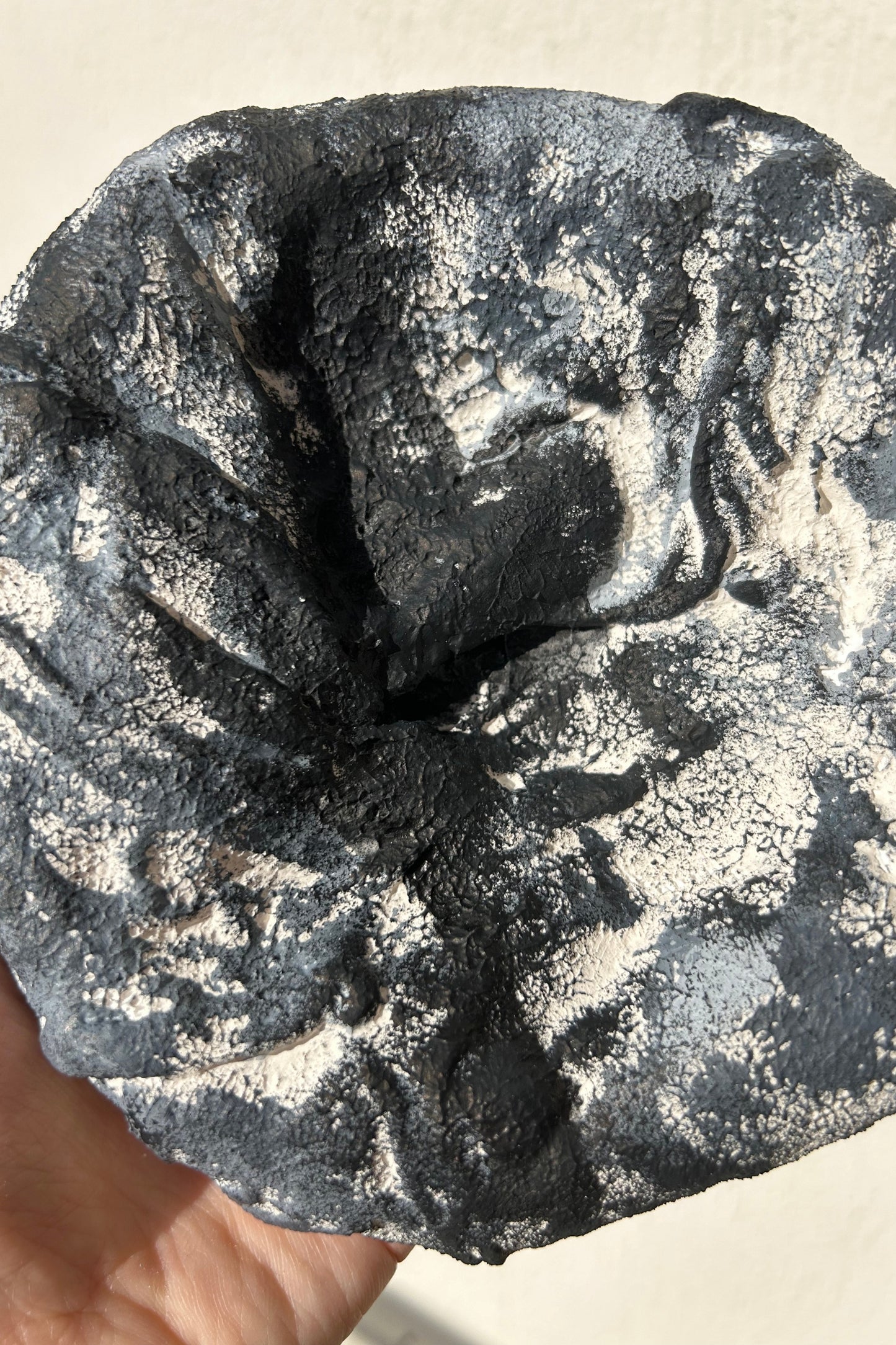 Close-up of handmade plaster texture on round wall sculpture