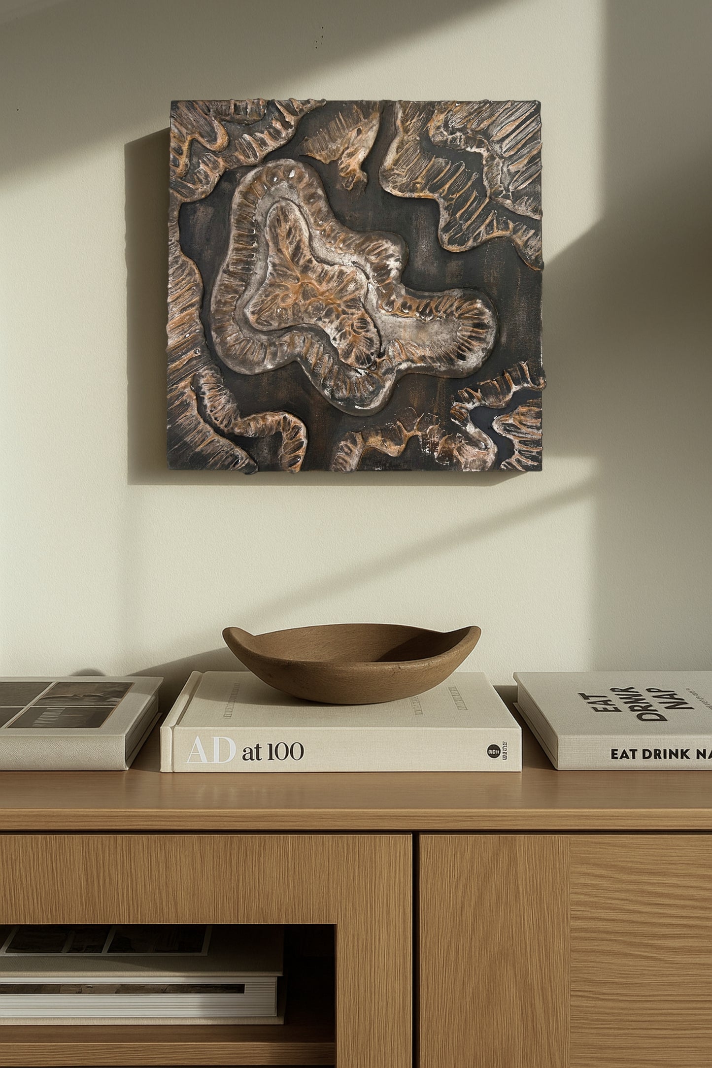 Handcrafted clay and plaster canvas featuring flowing sculptural texture