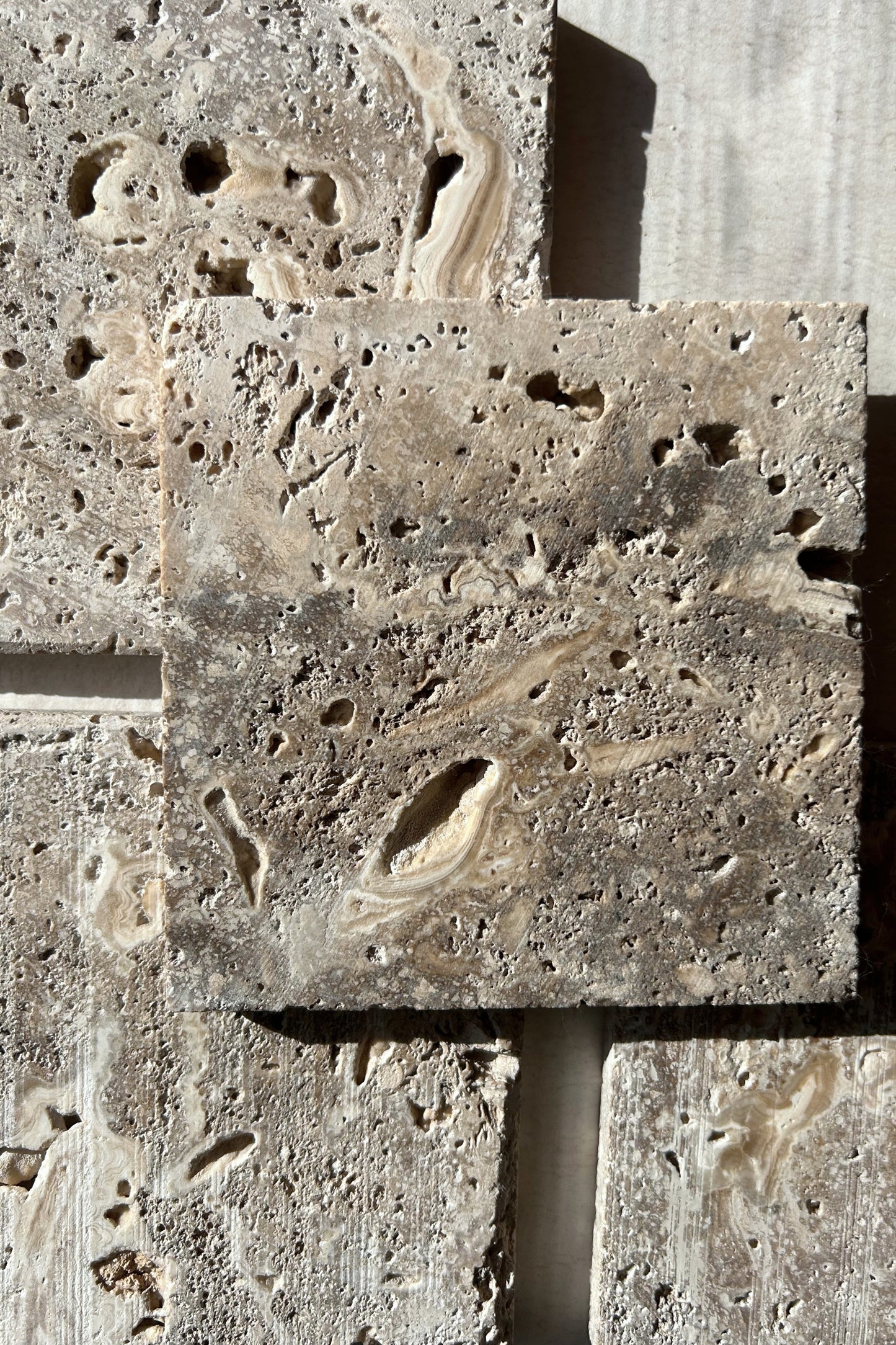 Overhead view of stacked travertine slabs for jewelry or product props