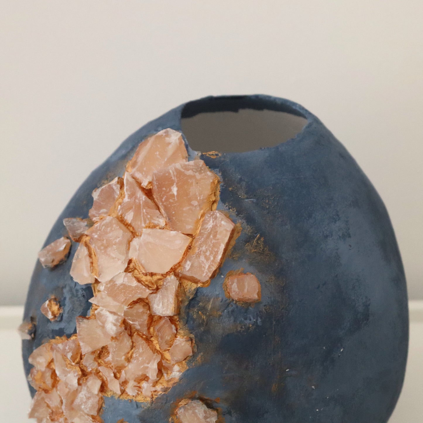 Detail view showing top opening and texture of handmade blue vase