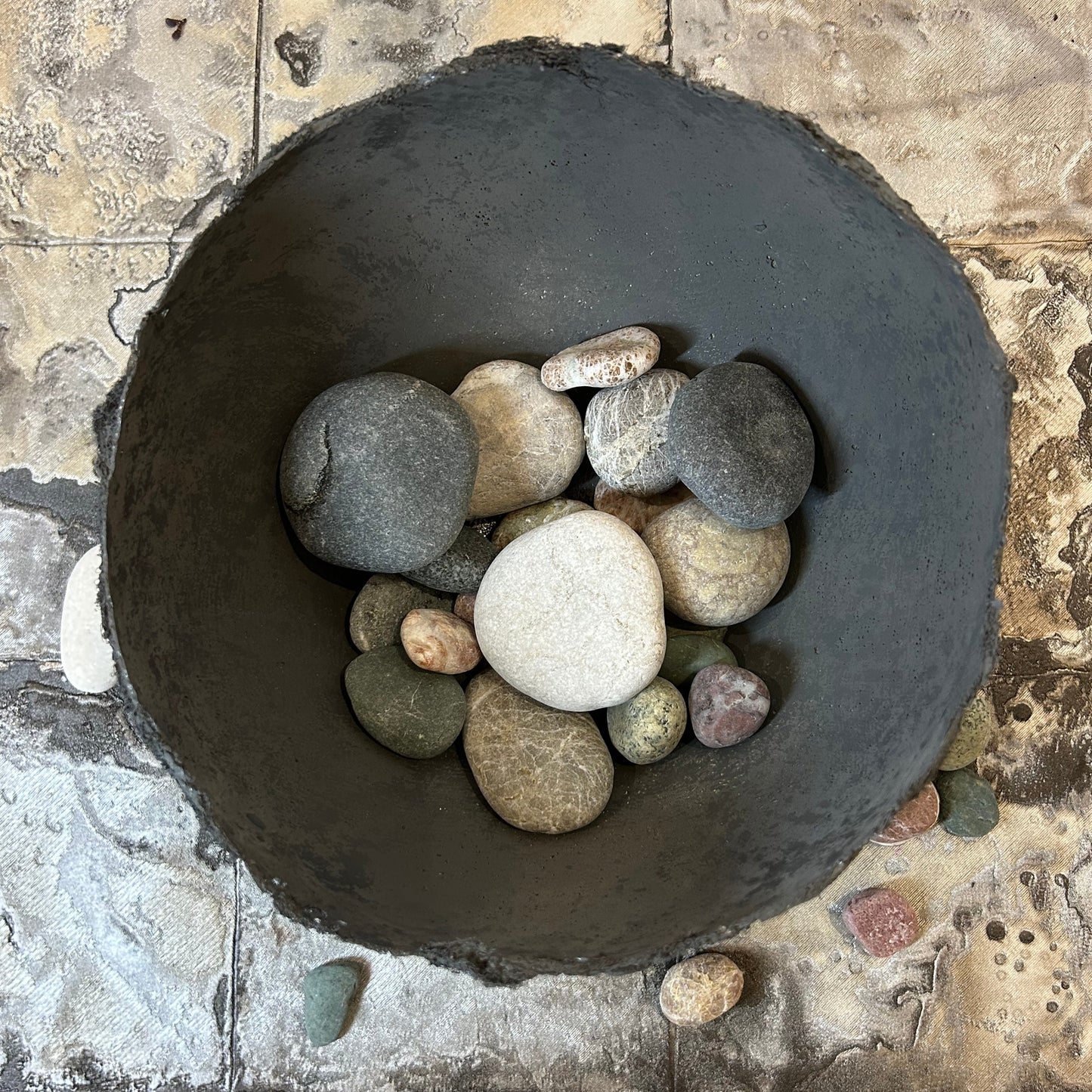 Top view of the textured wabi sabi bowl filled with decorative stones.