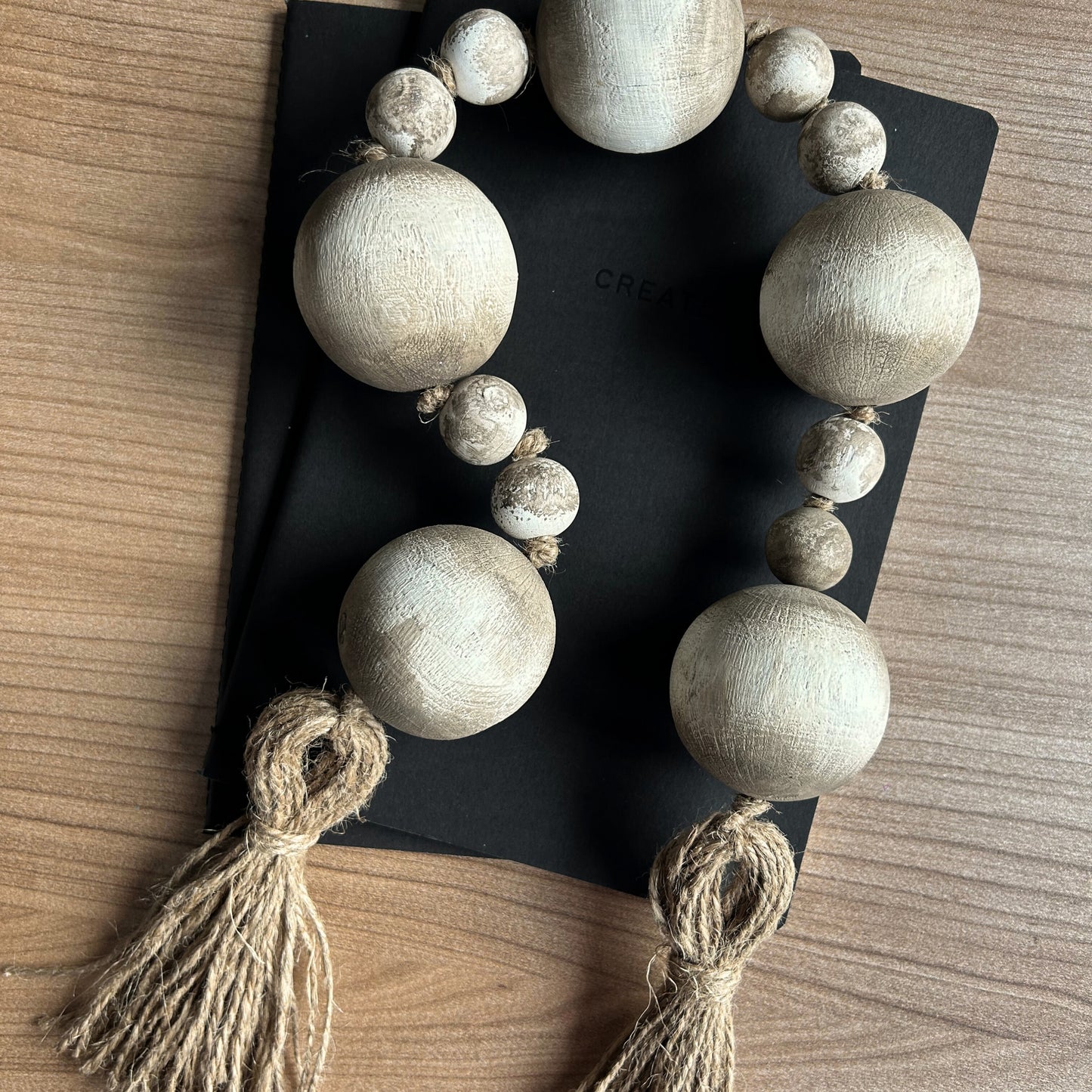 Handmade wooden garland styled on black for contrast