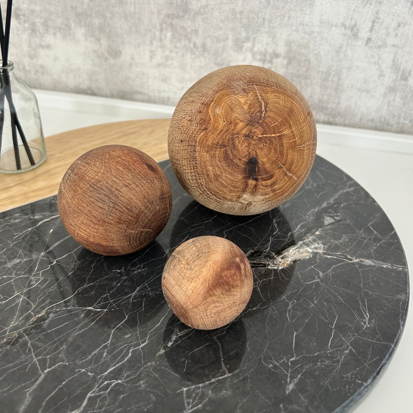 Close-up of handmade rustic wood beads with visible grain and earthy tone variations.