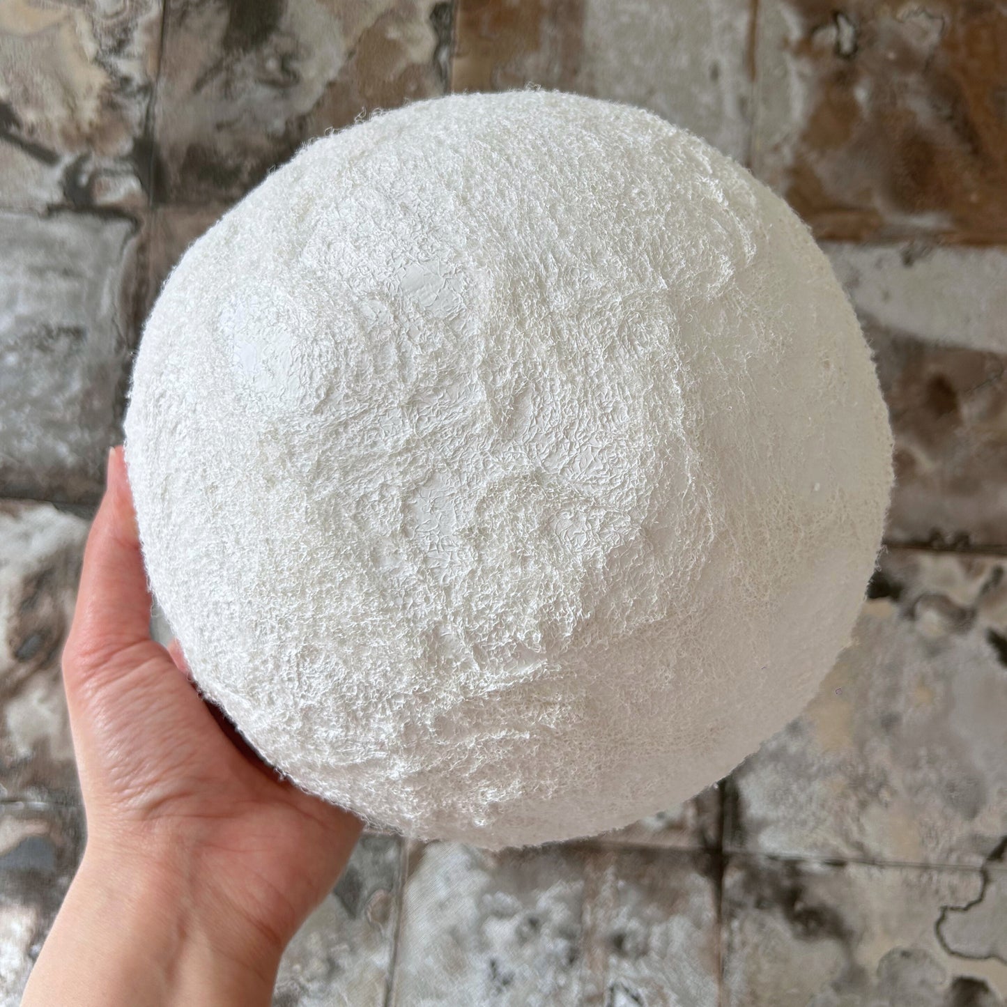Bottom view of a handmade wabi sabi bowl showing hand-formed curvature and texture