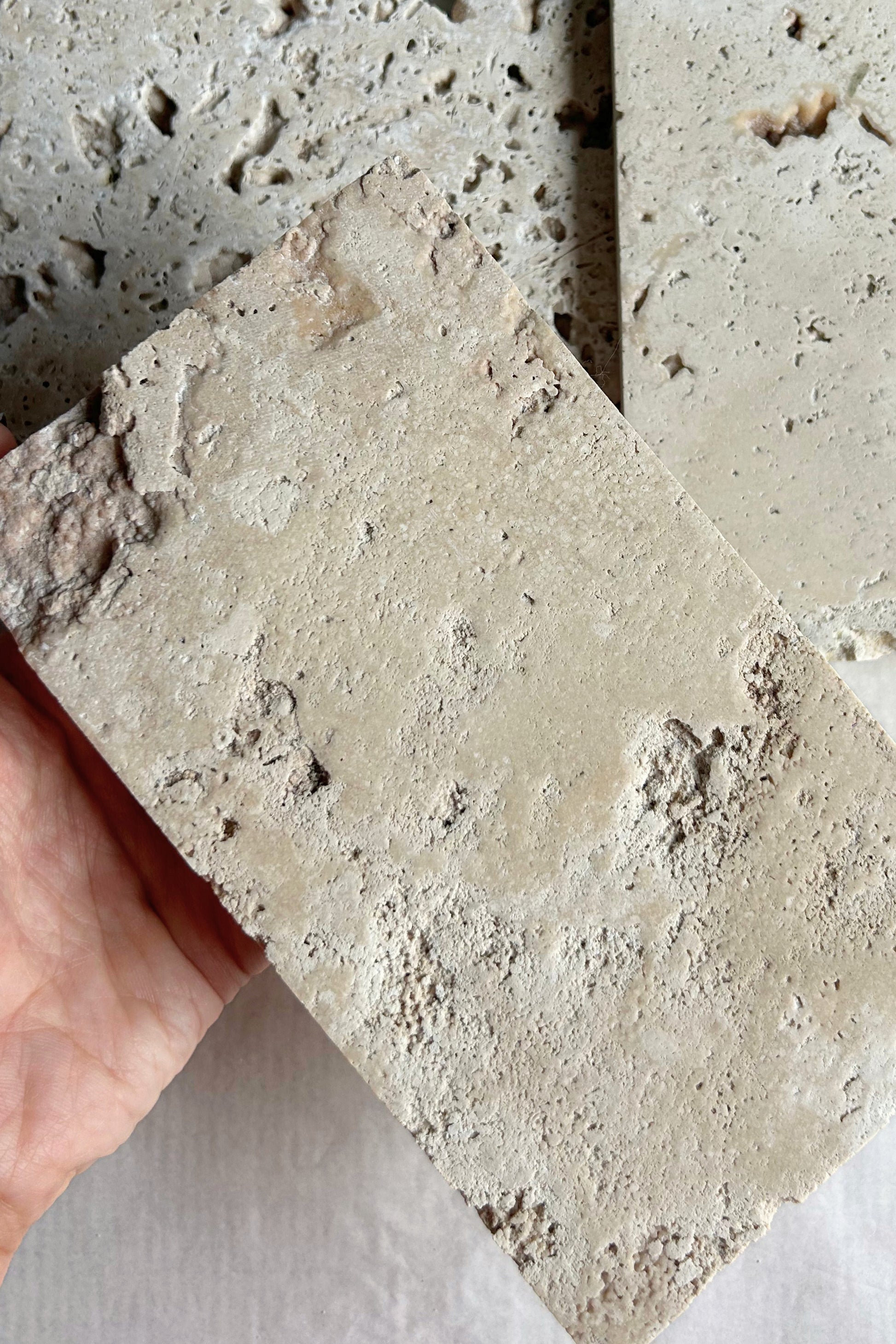 Close-up view of porous texture on raw travertine photo styling prop