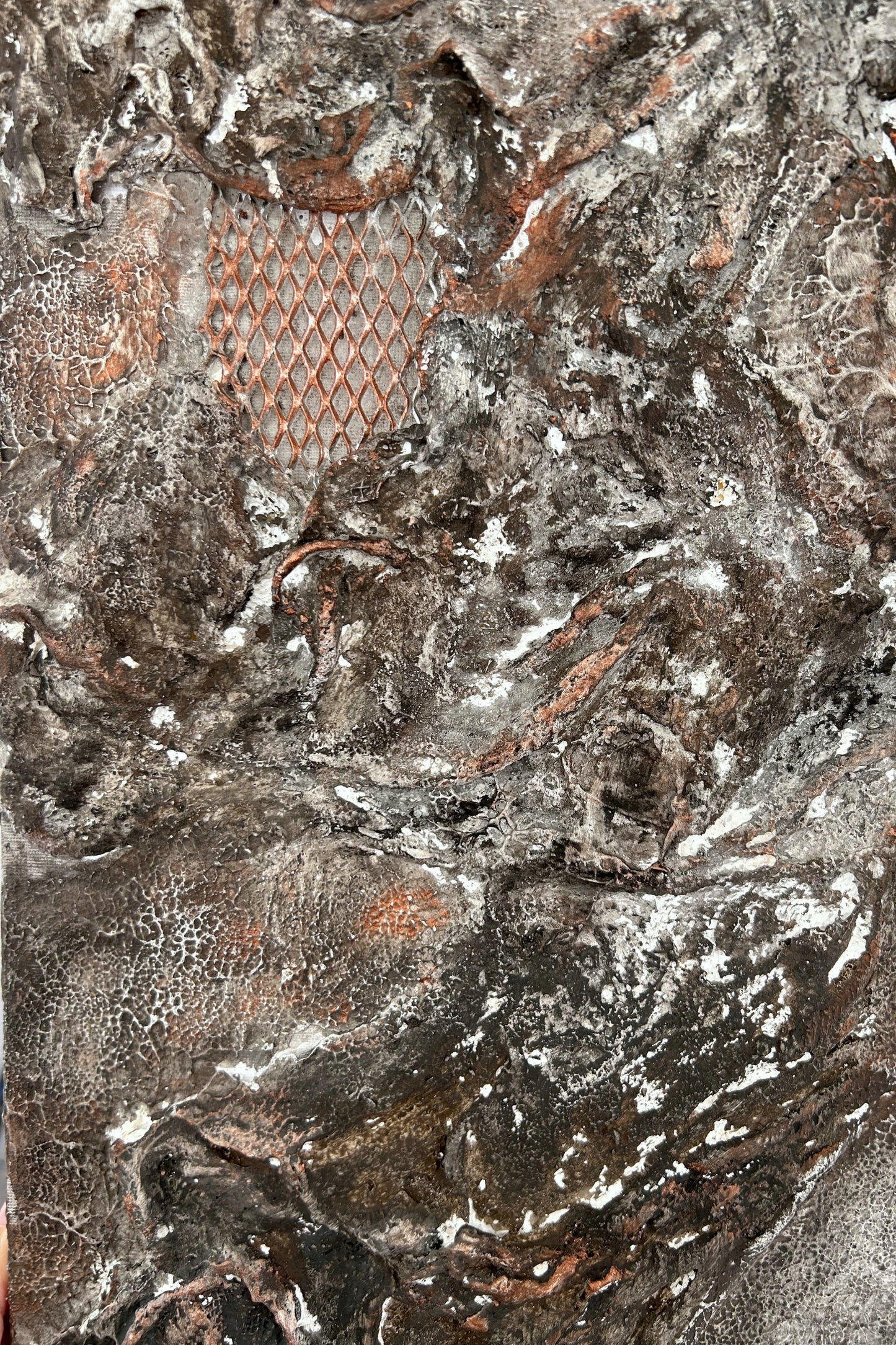 Side angle of wall art showing copper mesh and elevated layers of texture.