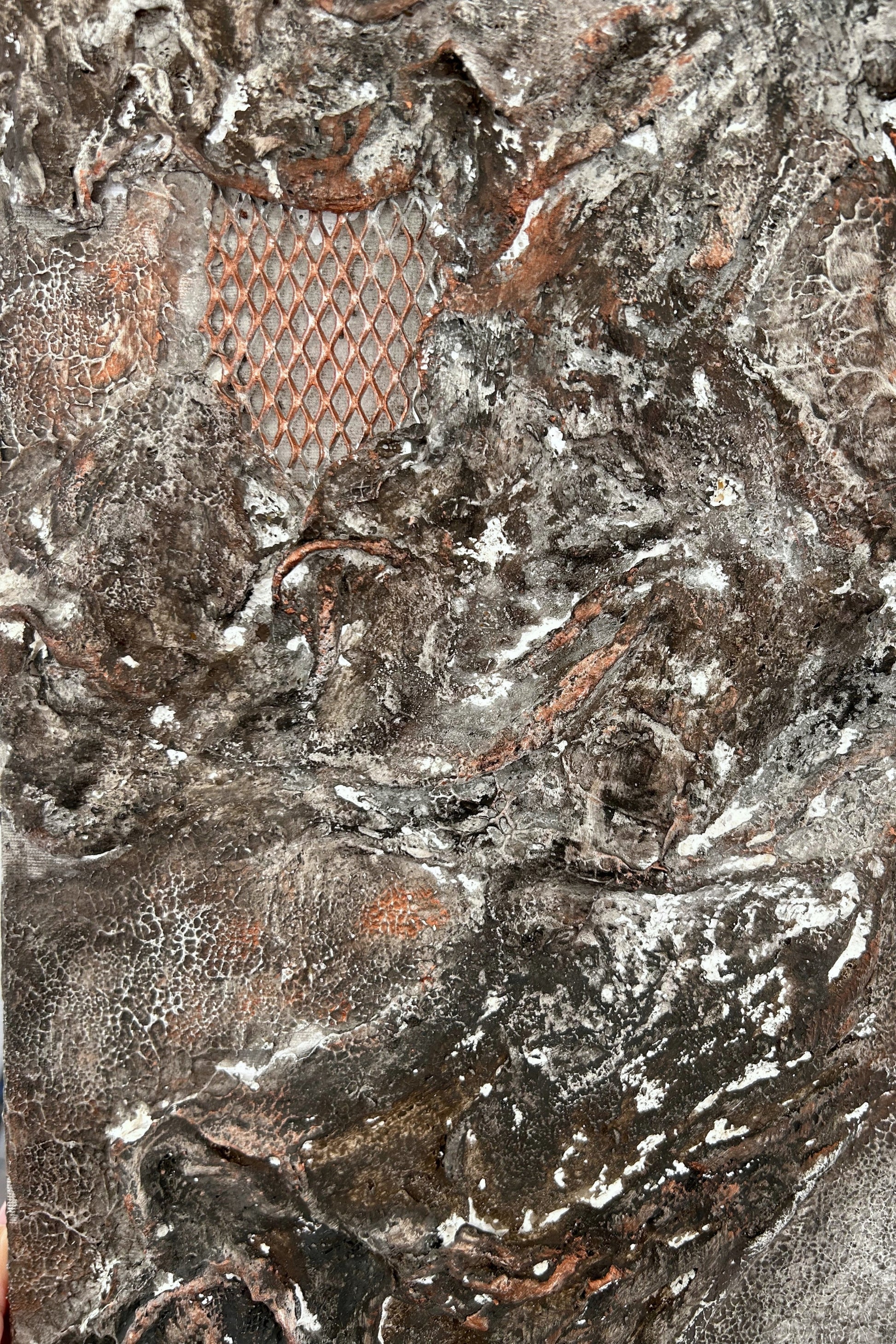 Side angle of wall art showing copper mesh and elevated layers of texture.