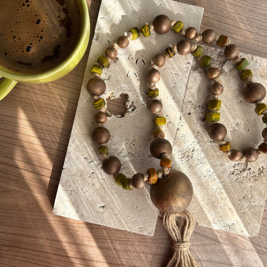 oho bead garland styled on neutral linen fabric with soft fall colors.
