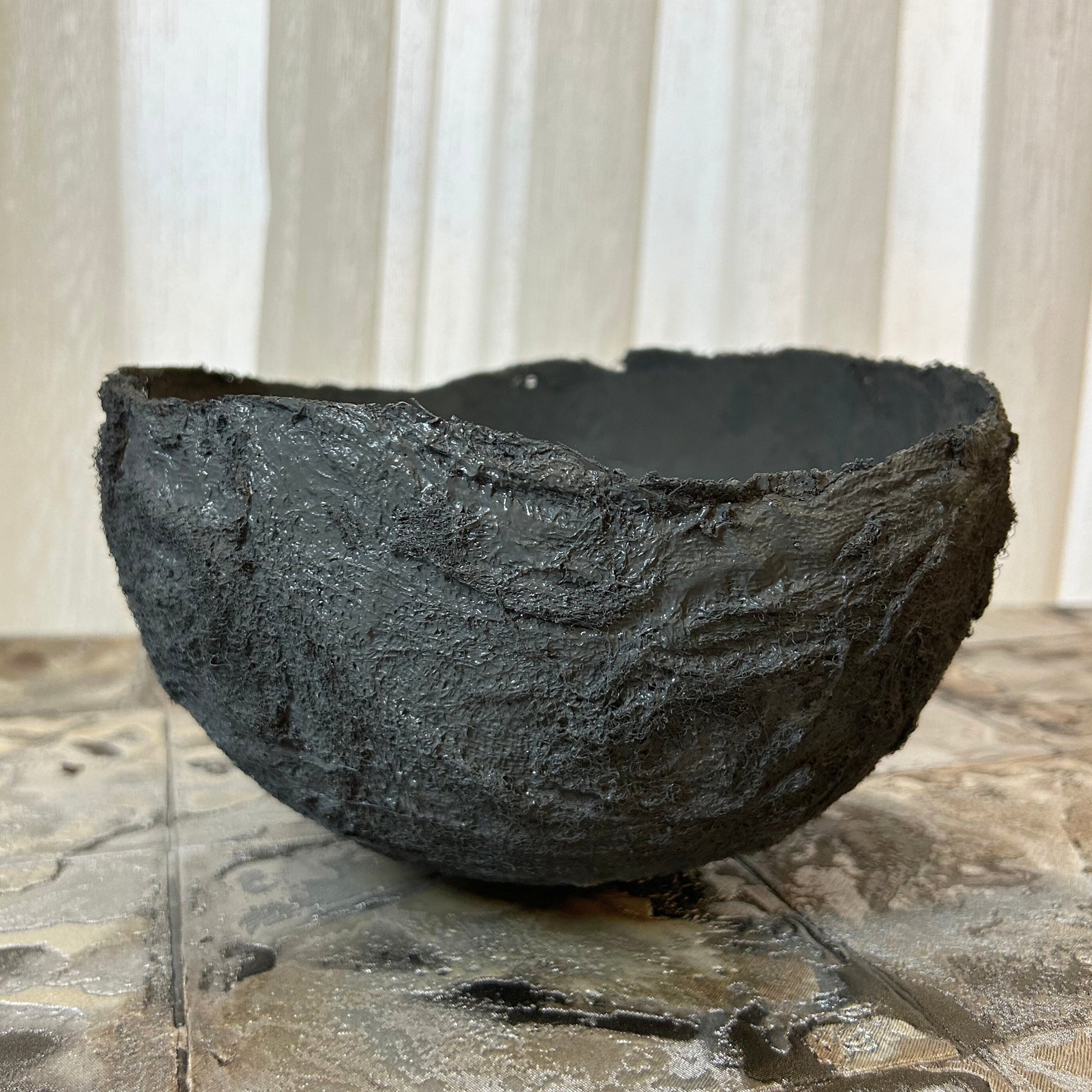  Close-up of handmade anthracite wabi sabi bowl with layered rustic texture.