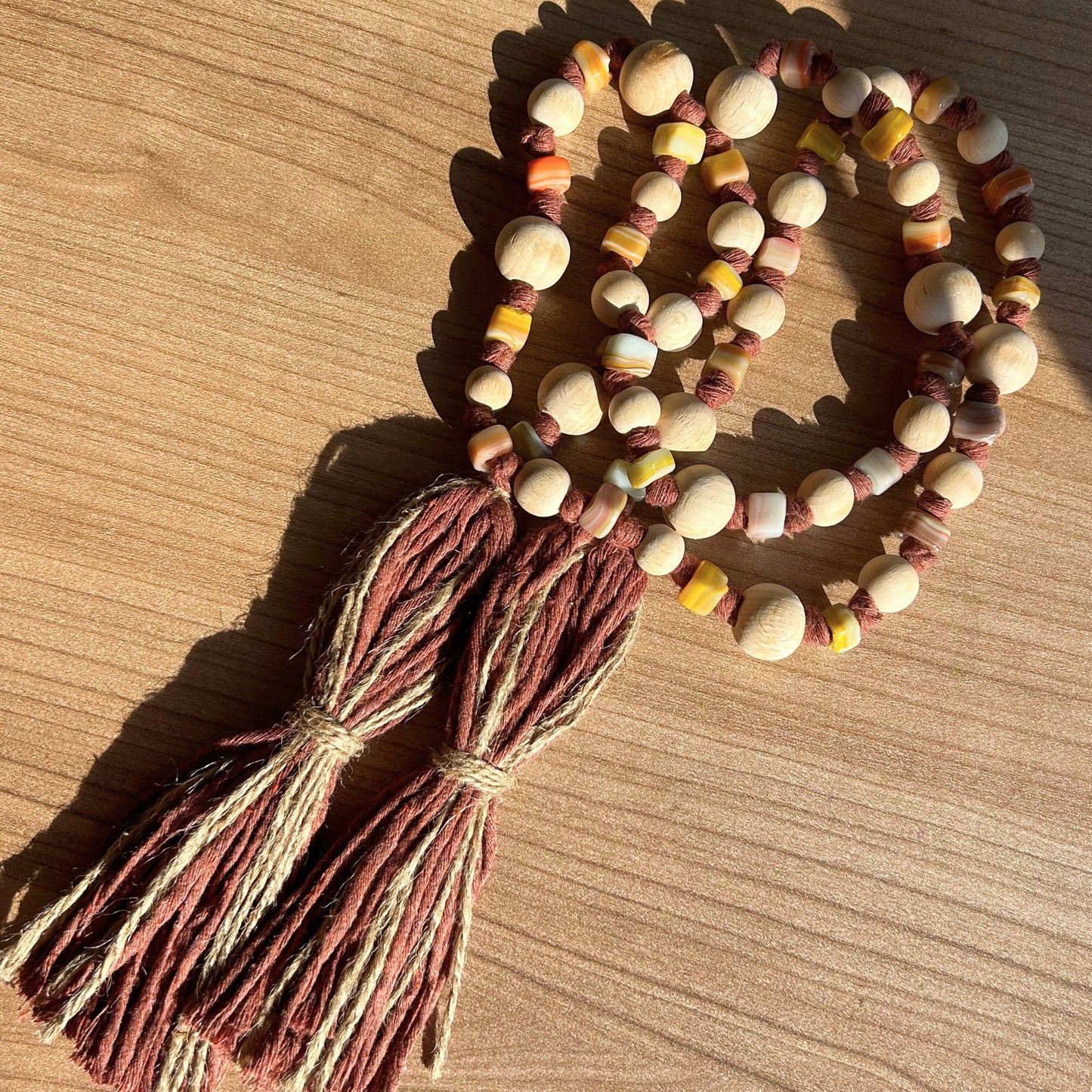 Handcrafted boho garland in circular shape with glass and wooden beads