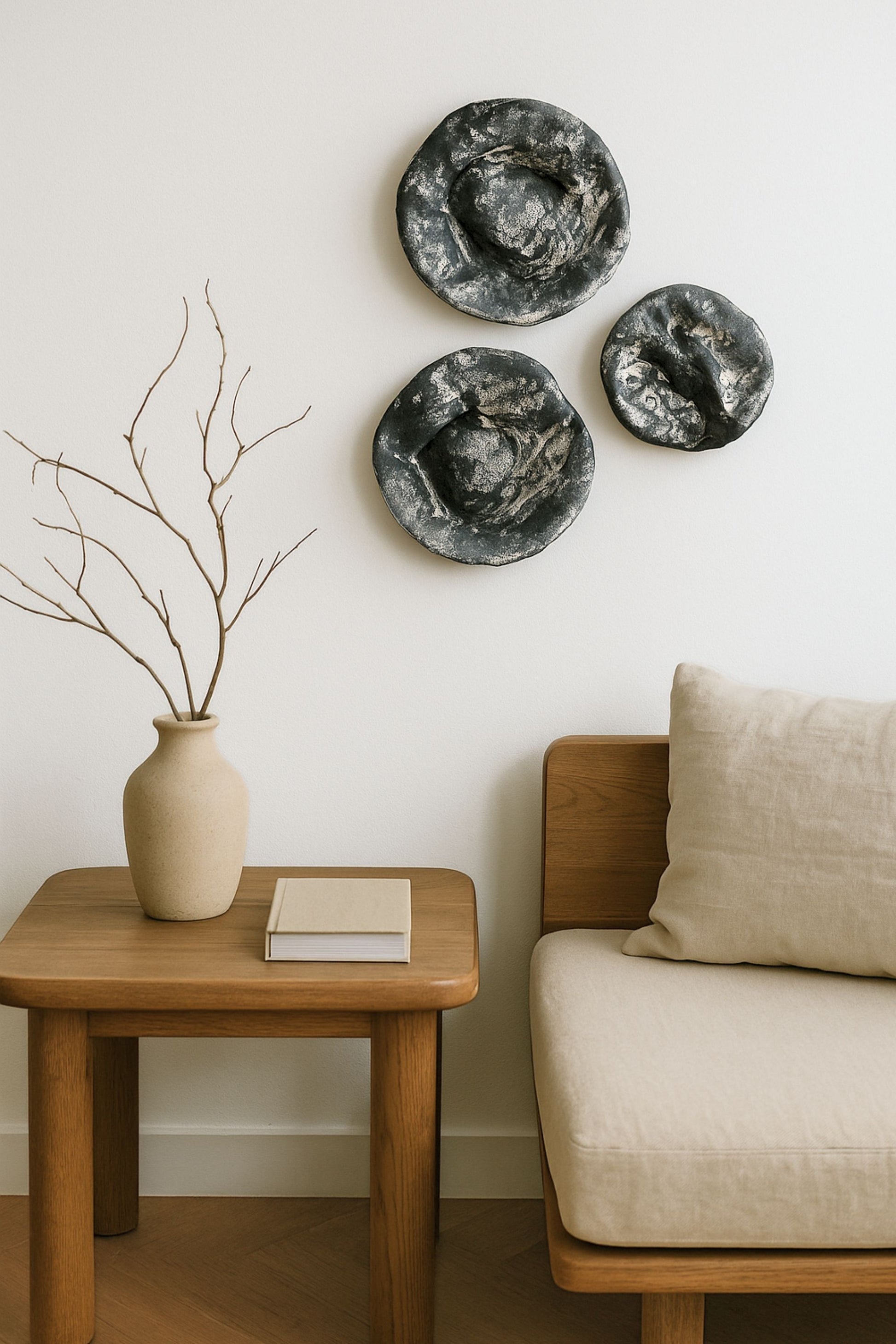 Japandi-style living room with three round textured wall art pieces on the wall