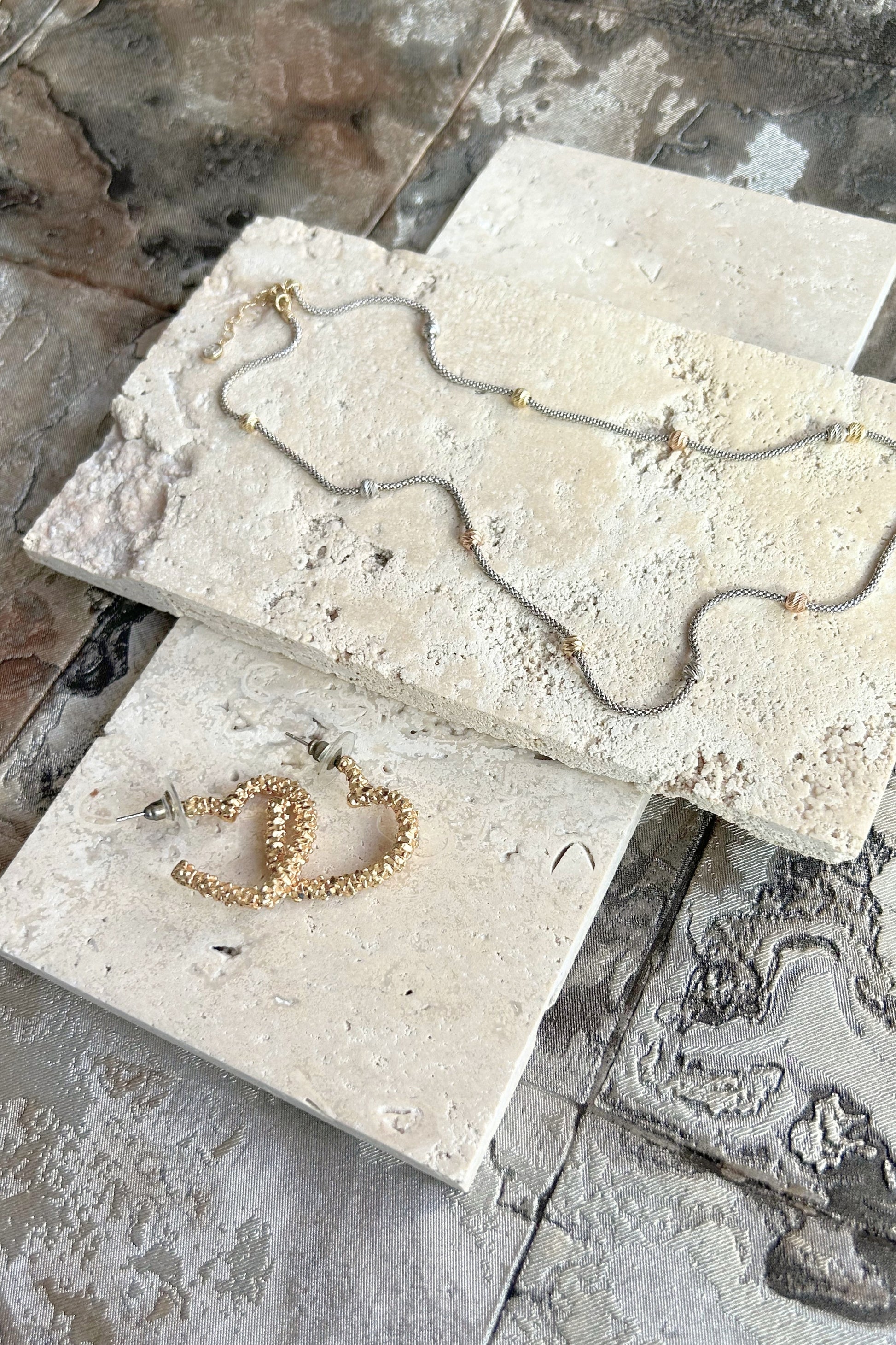 Organic travertine slabs stacked at angle for natural light photography styling