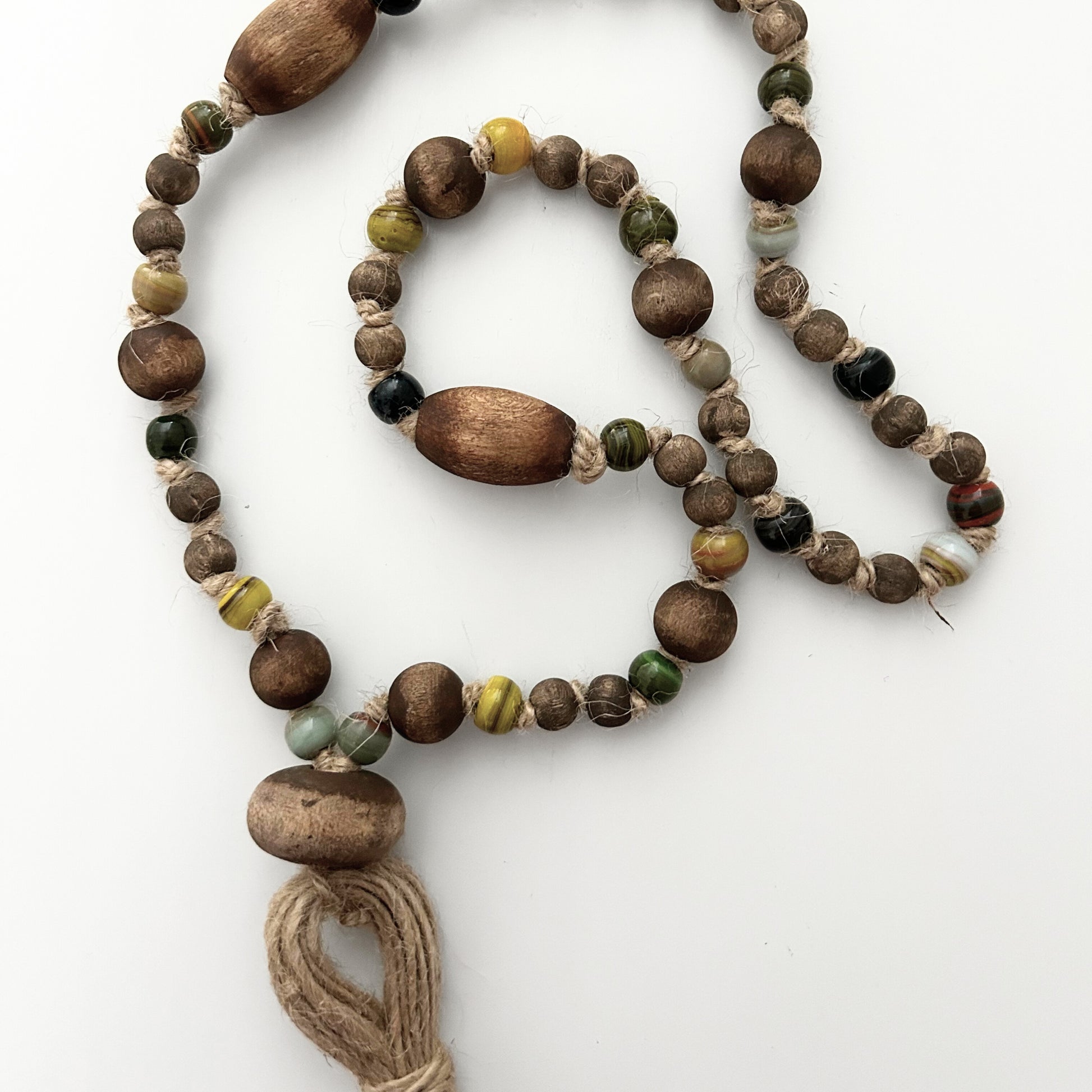 Two-strand handcrafted garland with earthy beads and natural fiber tassel