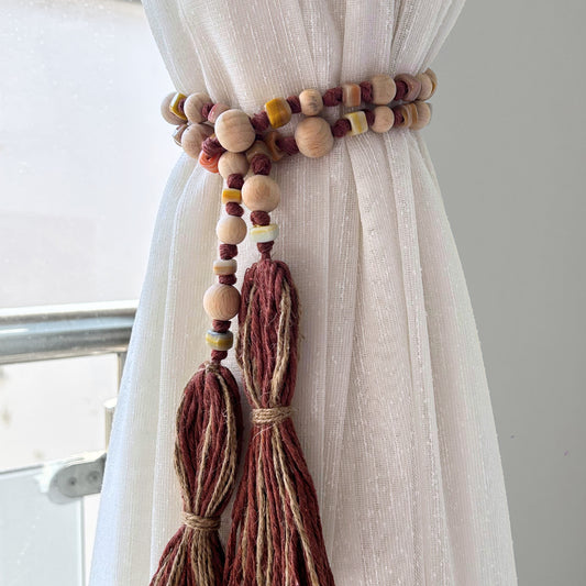 Earth-toned handmade curtain tieback with wooden and glass bead garland