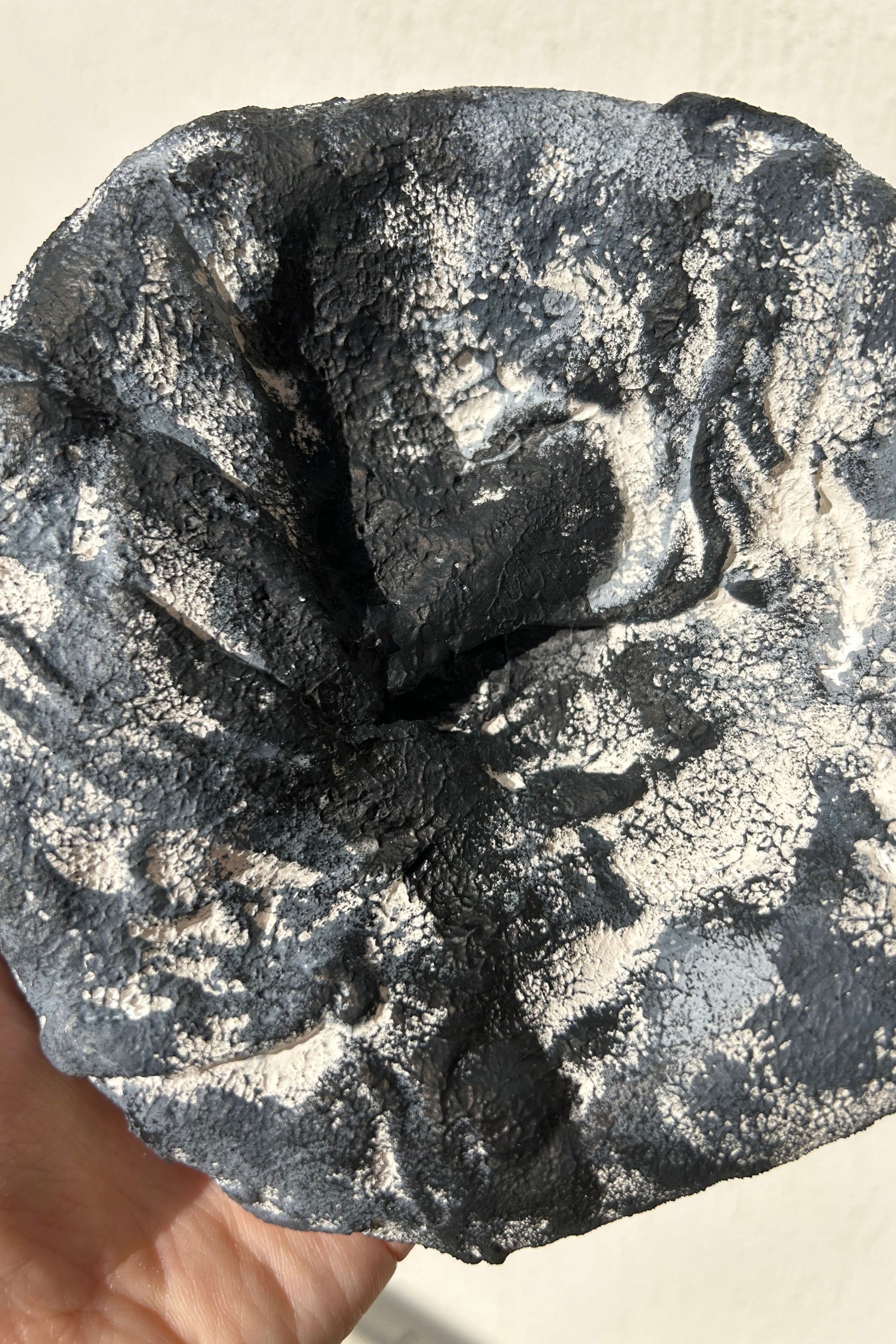 Close-up of handmade plaster texture on round wall sculpture