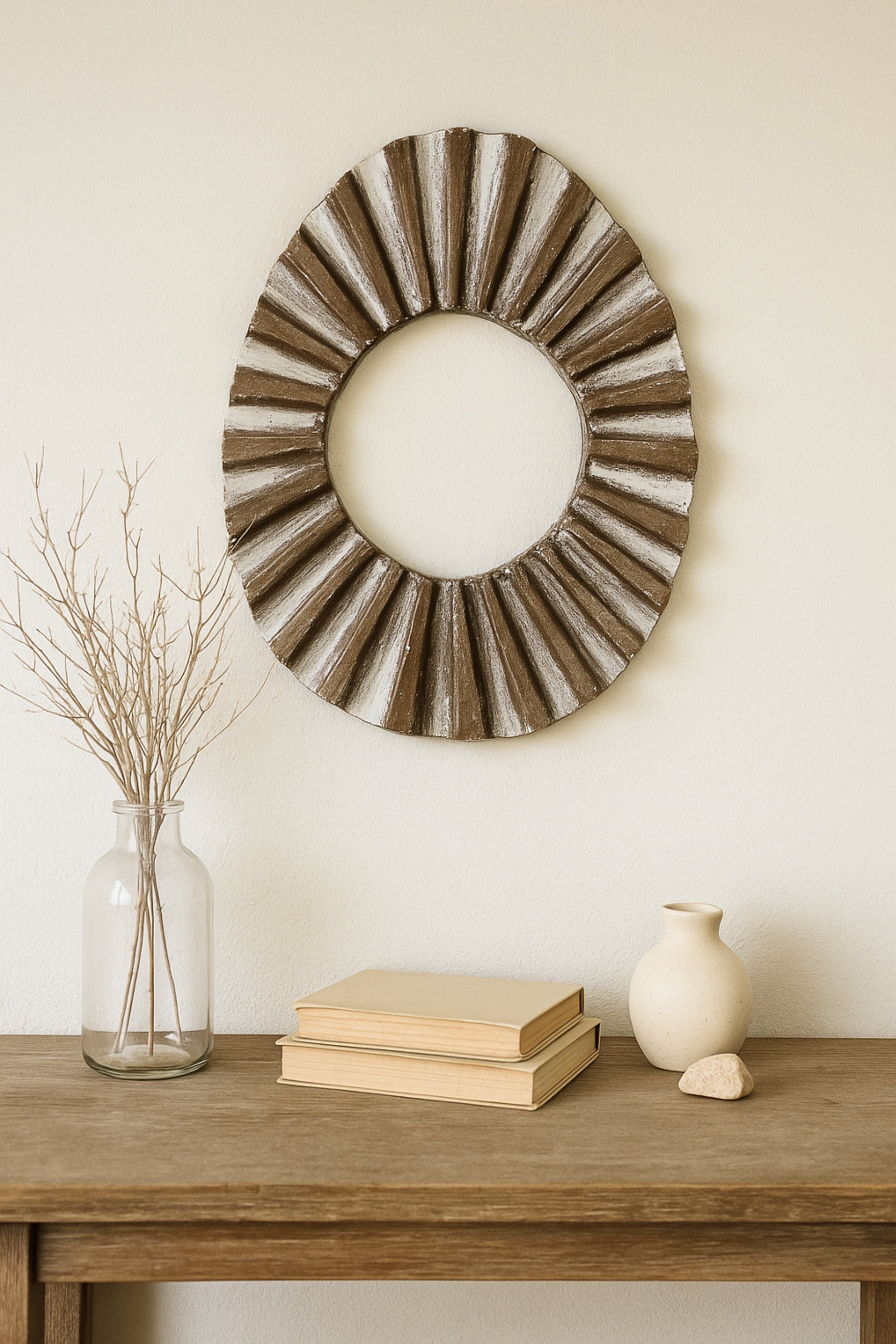 Wall sculpture styled above a console with neutral ceramics in a japandi living space